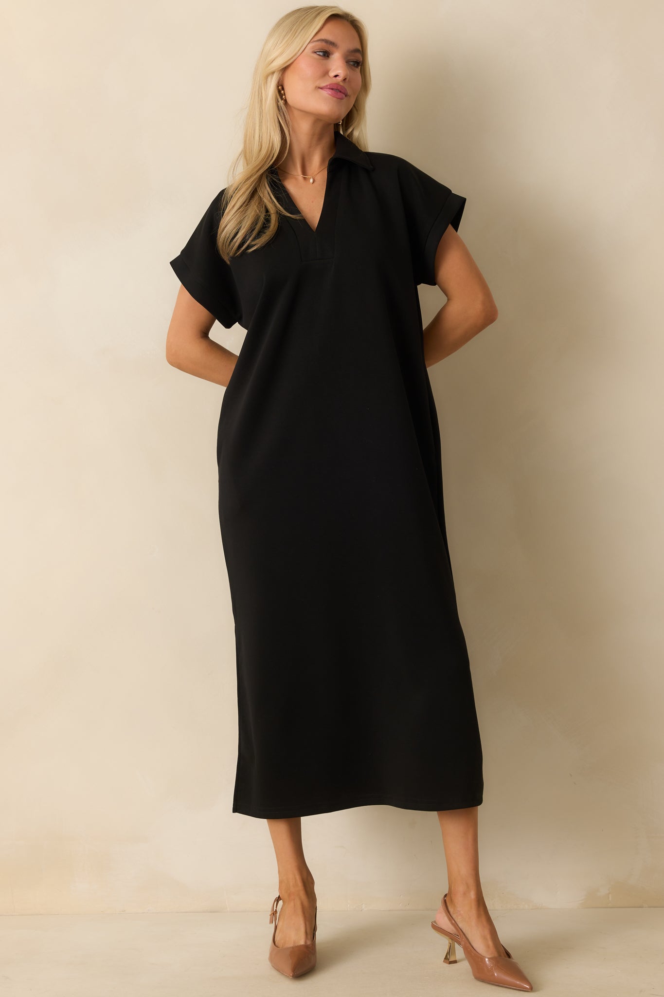 Short-sleeve black dress with a collared neckline and soft, everyday fabric.