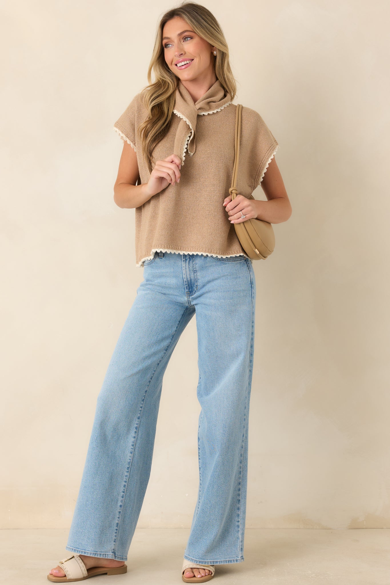 Short-sleeve knit top showcasing a built-in tie scarf, ivory contrast edging, and an easy boxy fit.