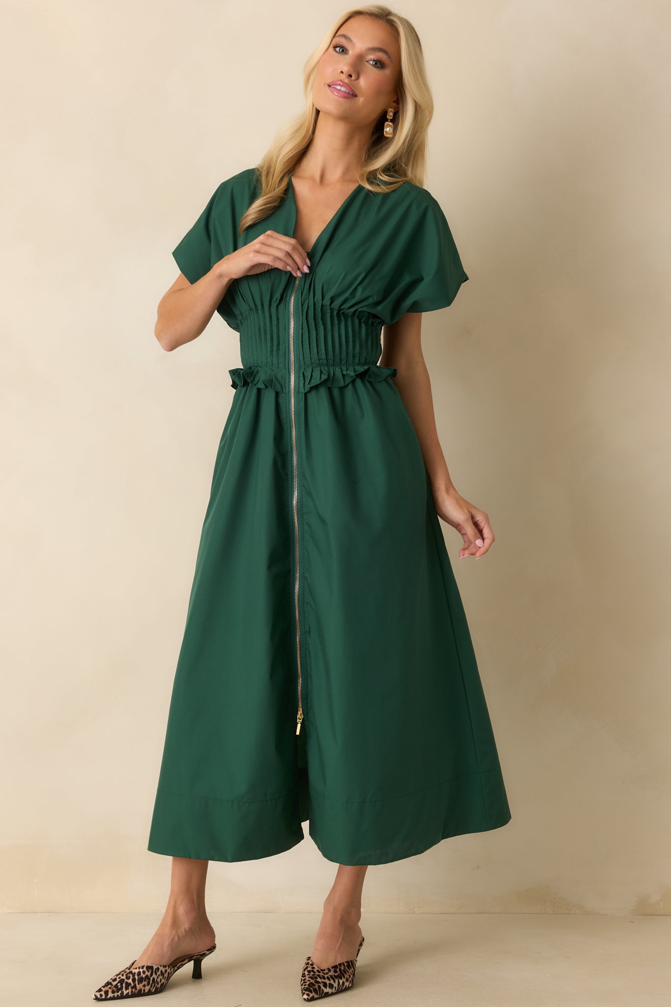 Short-sleeve maxi dress featuring a front zip closure and ruffled waistband detail for a feminine touch.