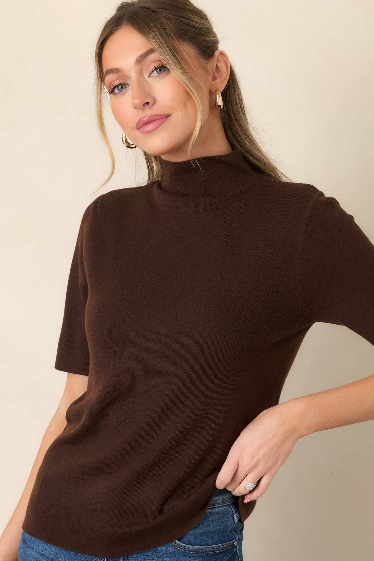 Short sleeve top showcasing the soft knit texture and elevated high turtleneck neckline.