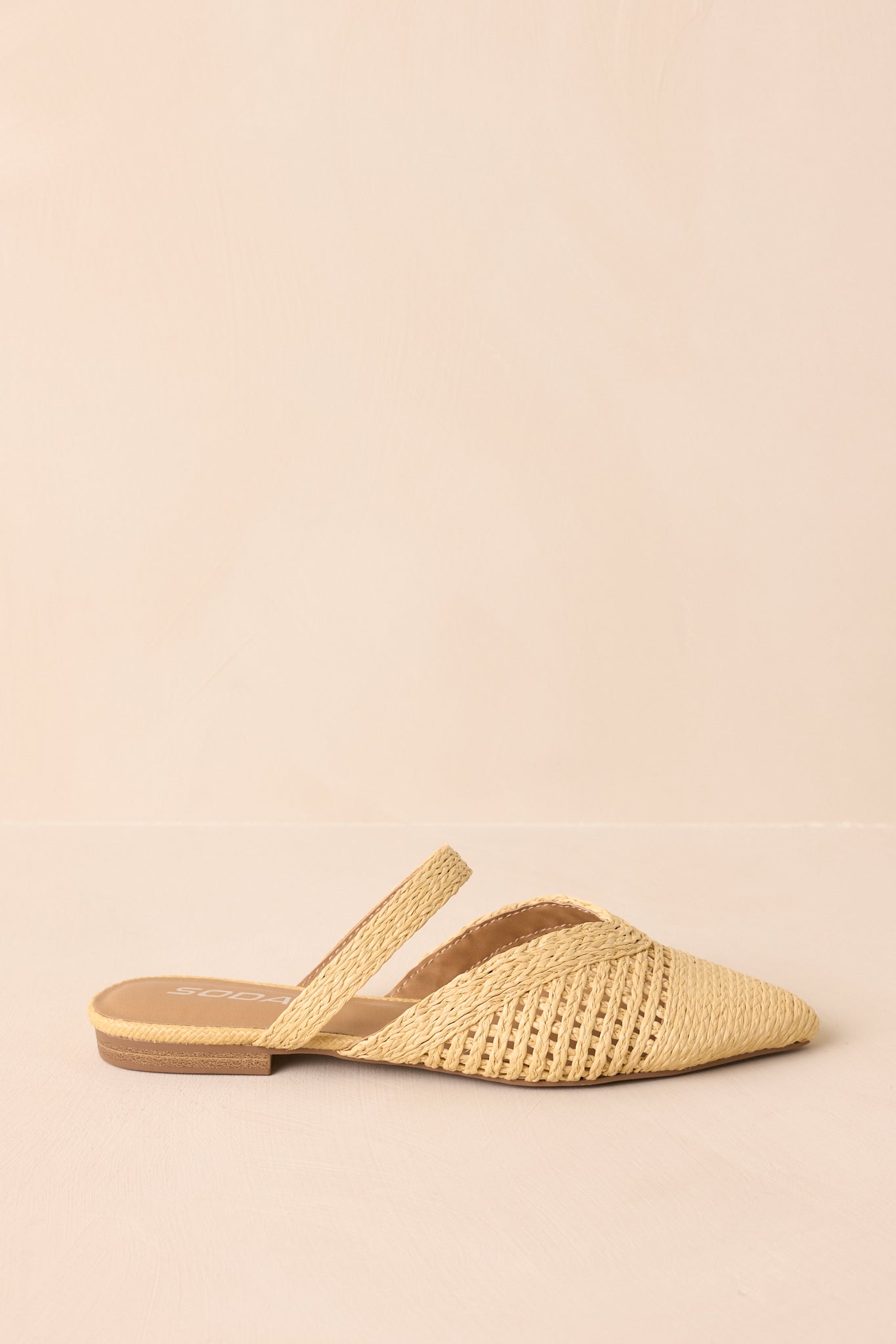 Side angle view highlighting the slip-on mule silhouette and flat sole.