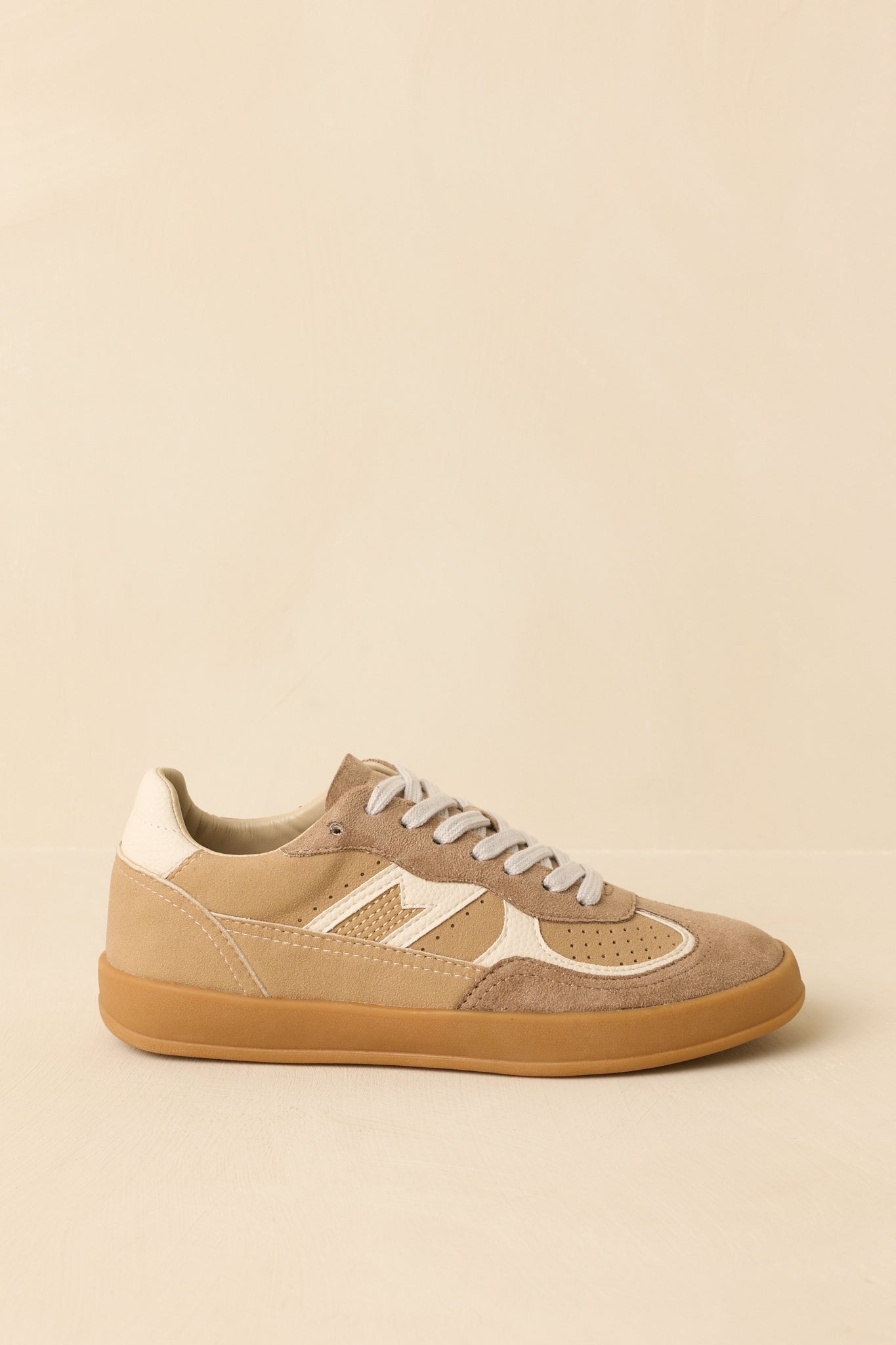 Side angle of tan sneakers showing contrast paneling and low-profile gum sole for comfortable wear.