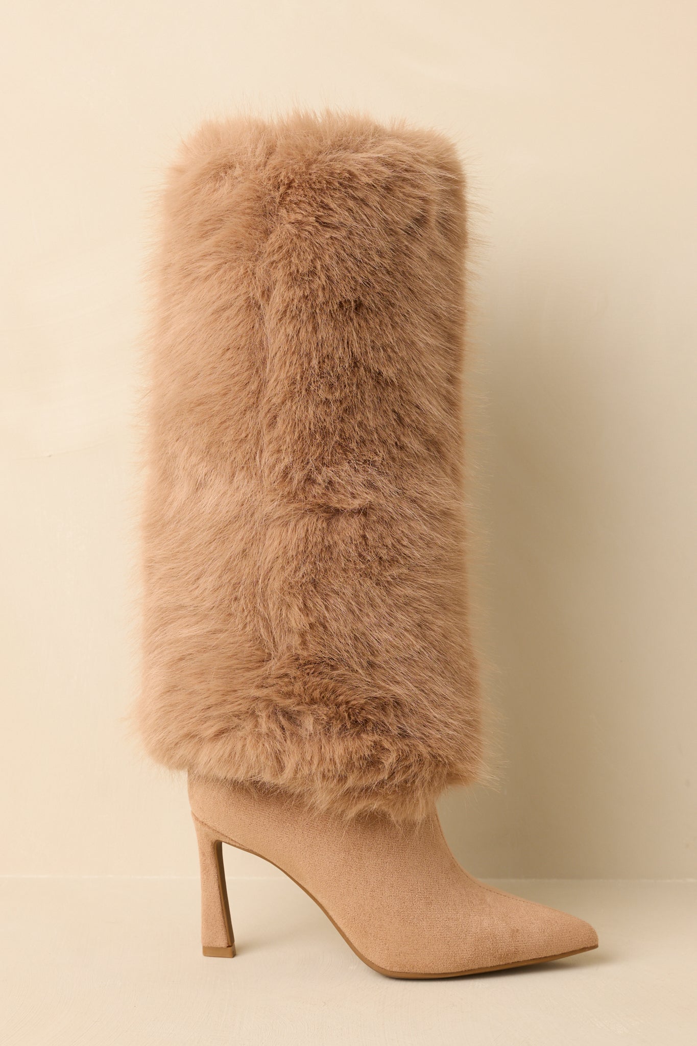 Side angle emphasizing the inner zipper closure and tall faux fur shaft of the boots.