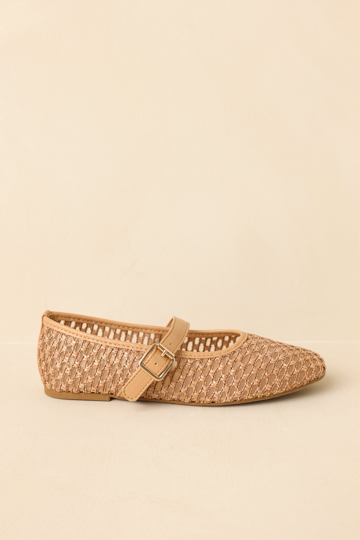 Side angle view highlighting the low-profile flat sole and clean silhouette of the woven upper.