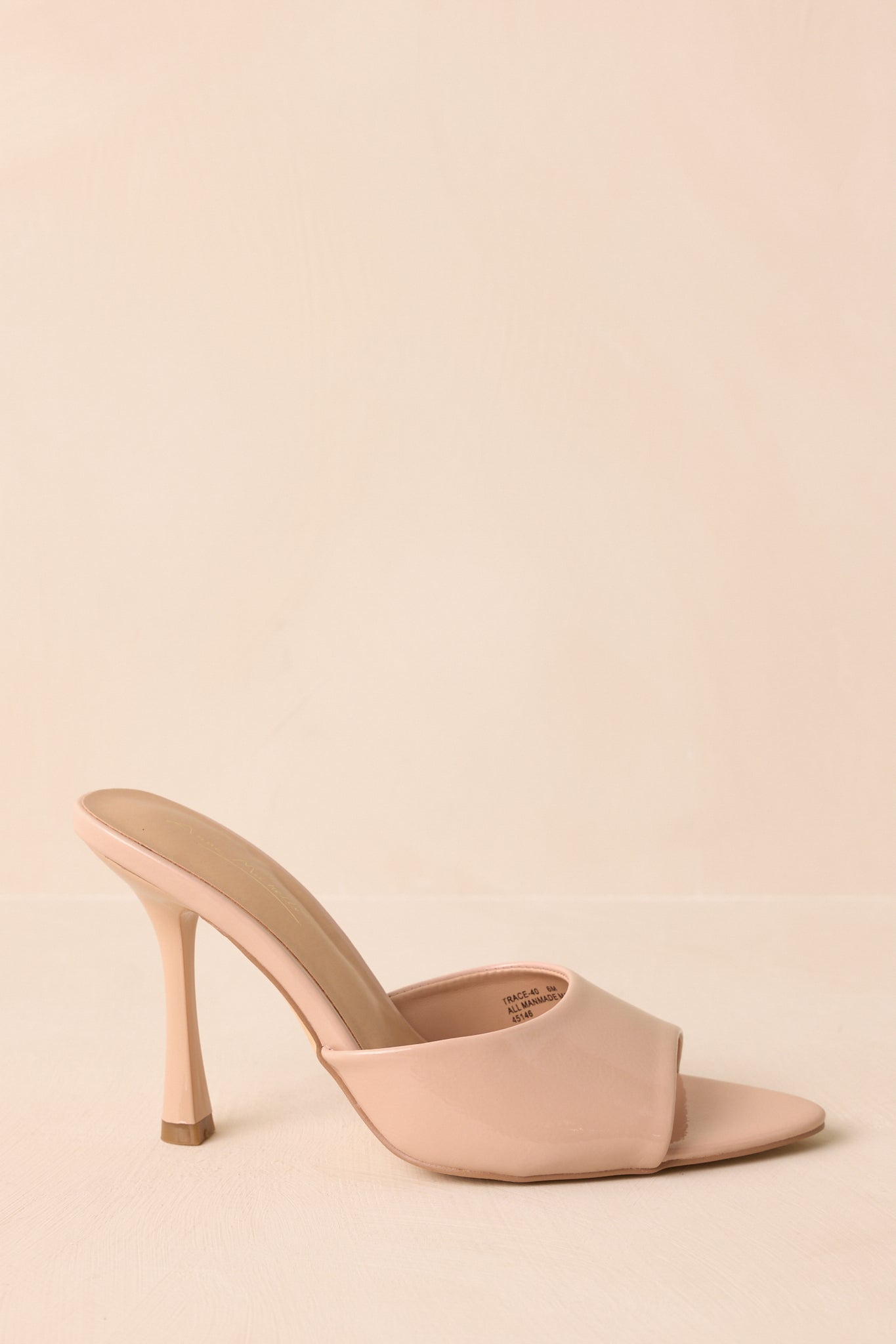 A side cropped angle of the mule heels highlighting the slim stiletto heel and slip-on silhouette.