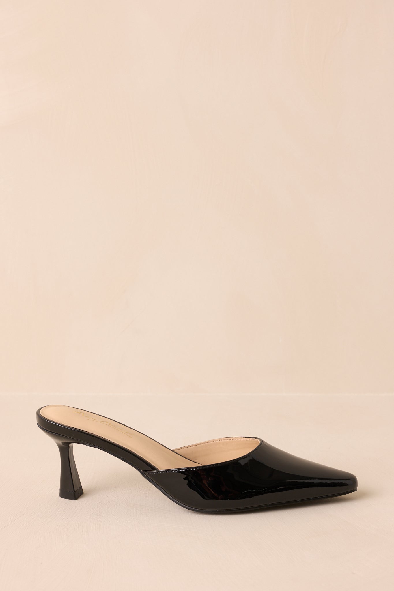 A side cropped view highlighting the slip-on mule design and flared stiletto kitten heel.