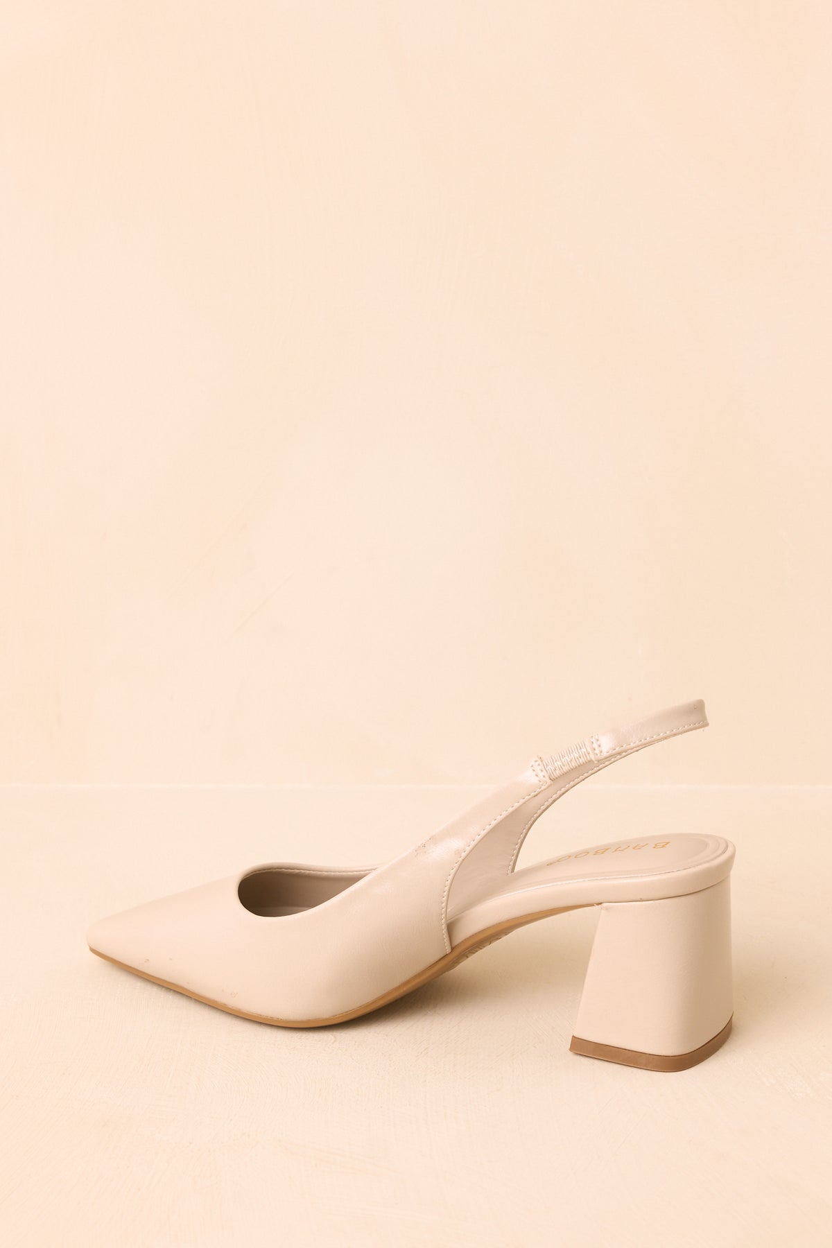 Side angle shows the pearl heels’ sleek pointed toe, back strap, and sturdy block heel.