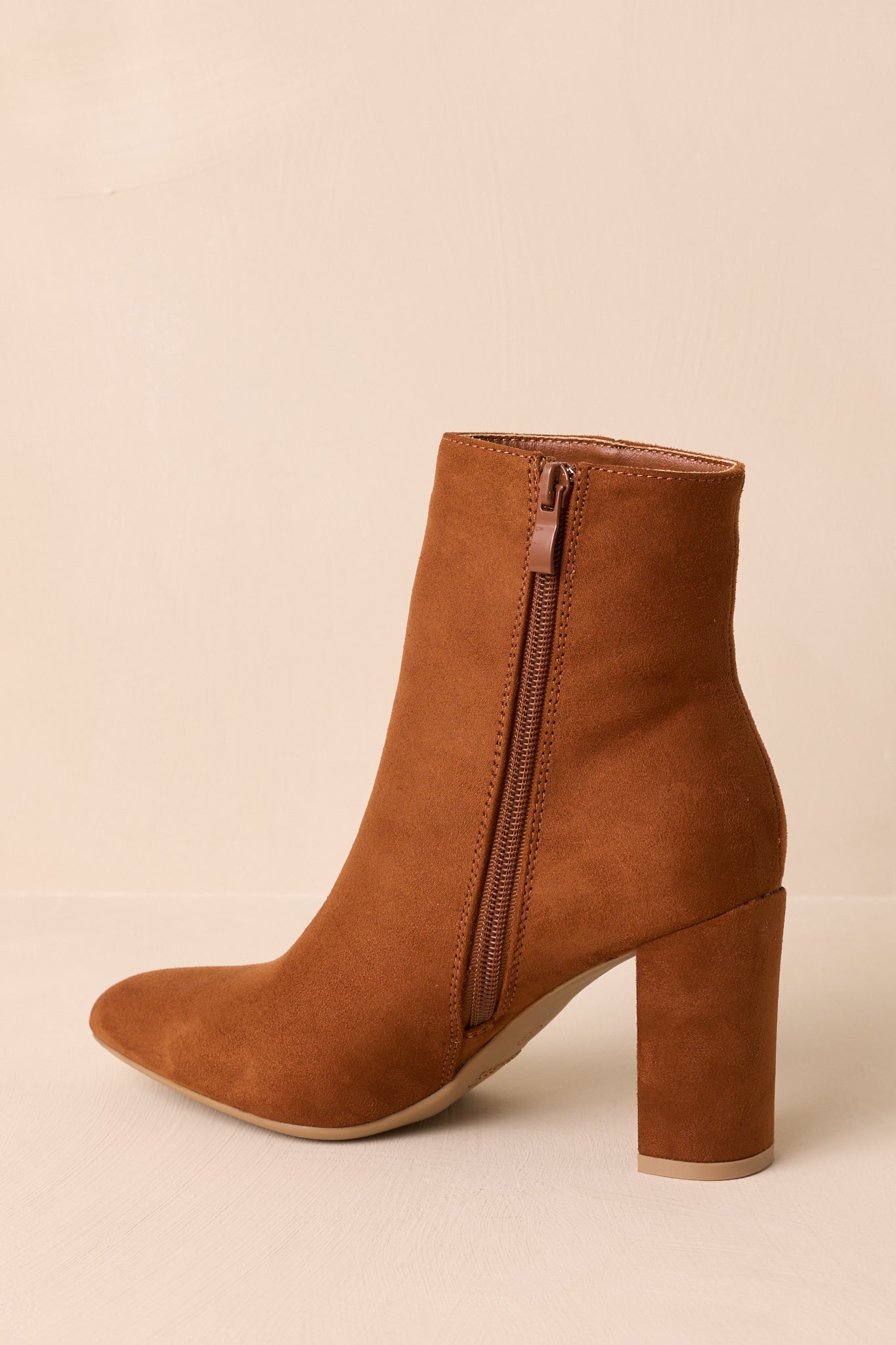 Side profile emphasizing the inner zipper and smooth faux suede finish.