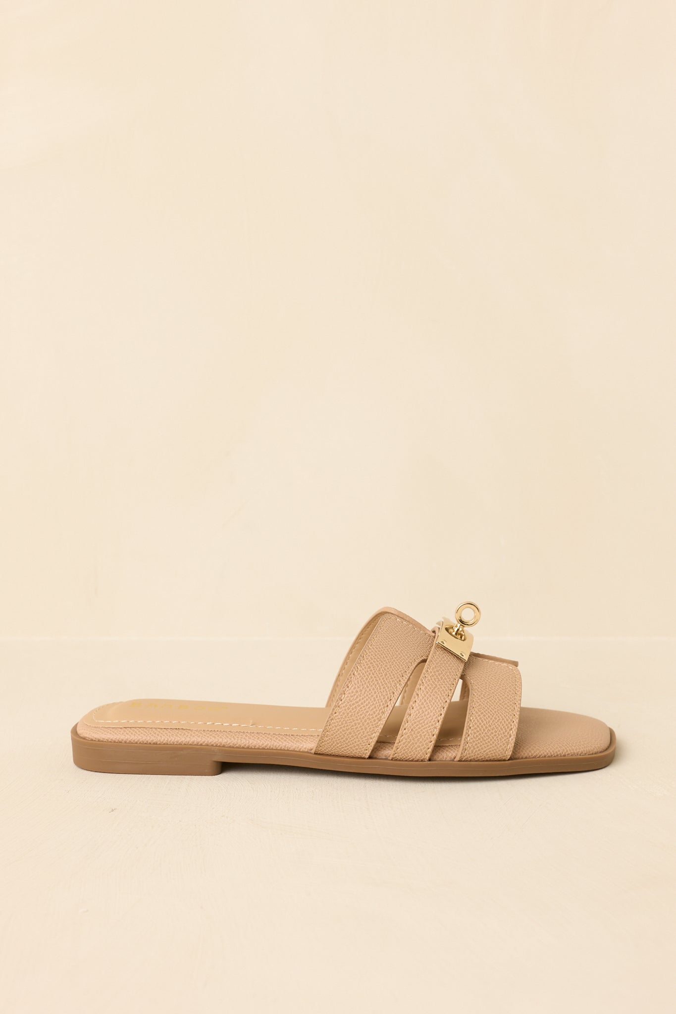 Side profile highlighting flat sole and minimalist slip-on construction.
