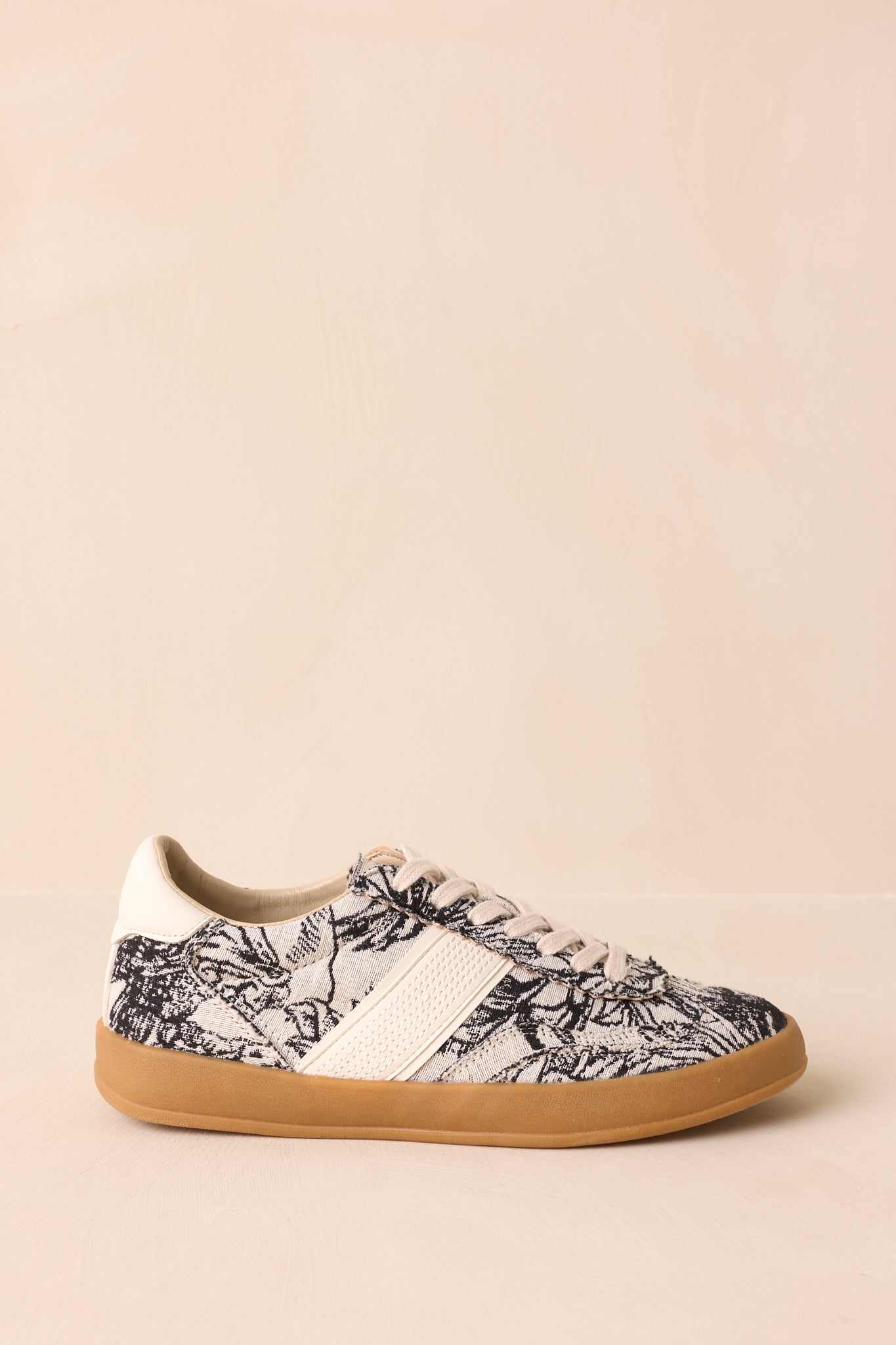 Side profile of sneakers highlighting the floral print canvas, cream overlays, and gum rubber sole.