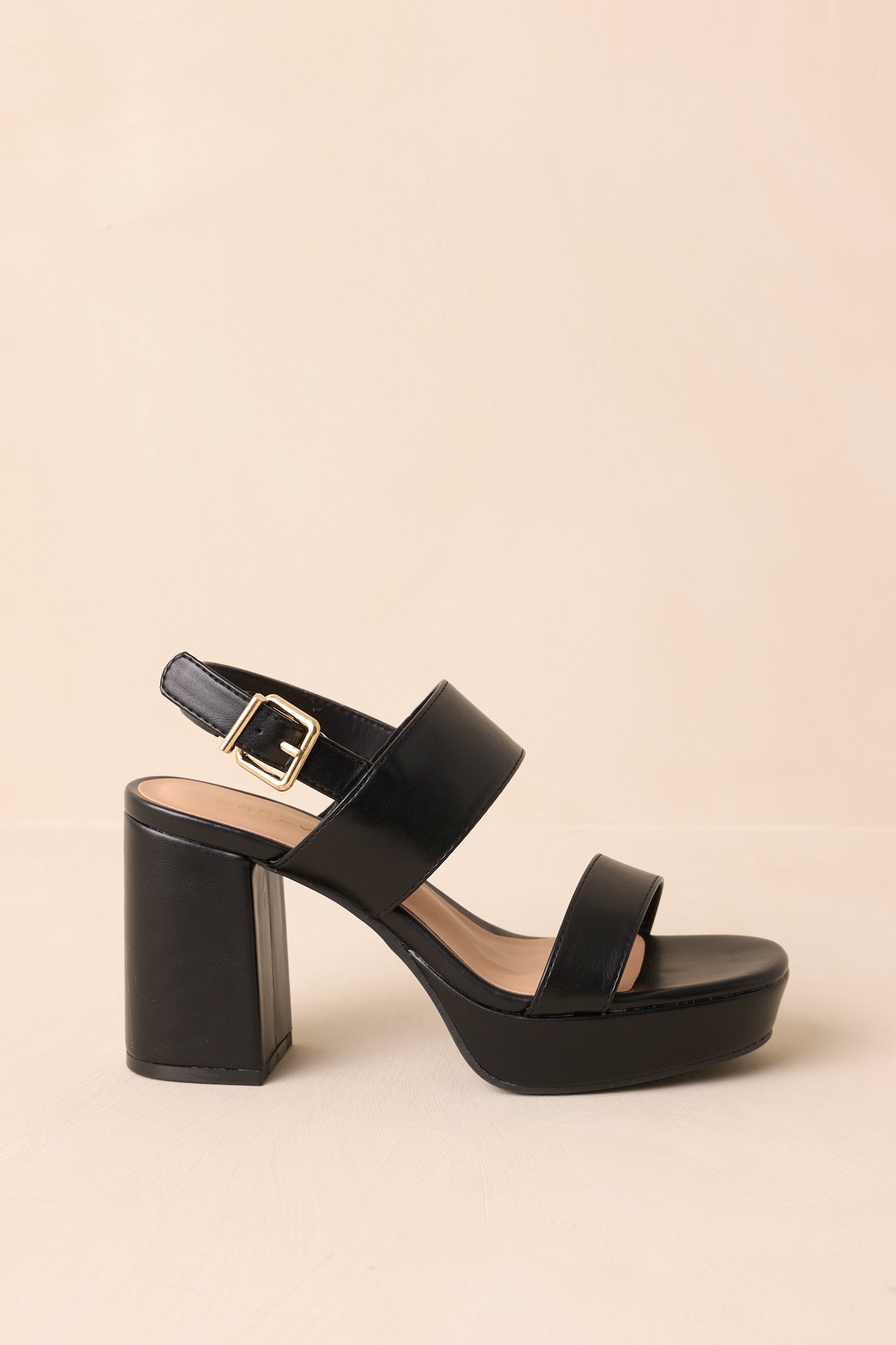 Side view of the black faux leather heels highlighting the platform sole and block heel height.