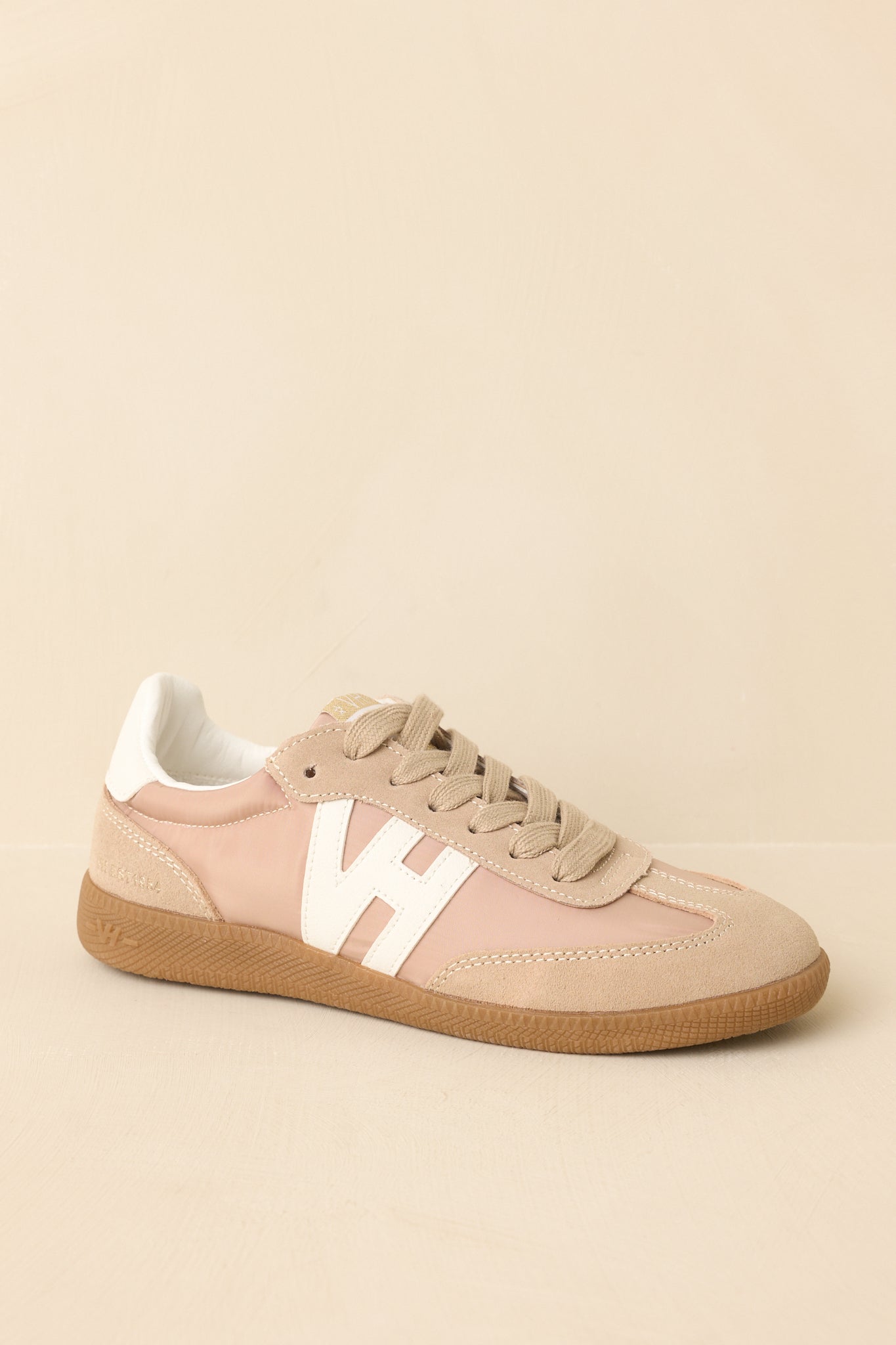 Side angle view highlighting the smooth upper, lace placement, and streamlined shape of the sneaker.