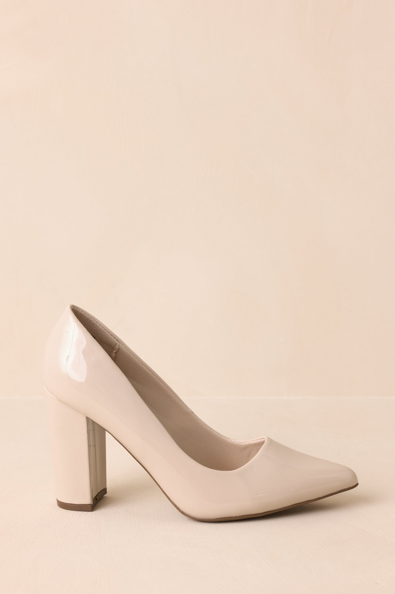 A side shot focusing on the slip-on design and shiny ivory surface.