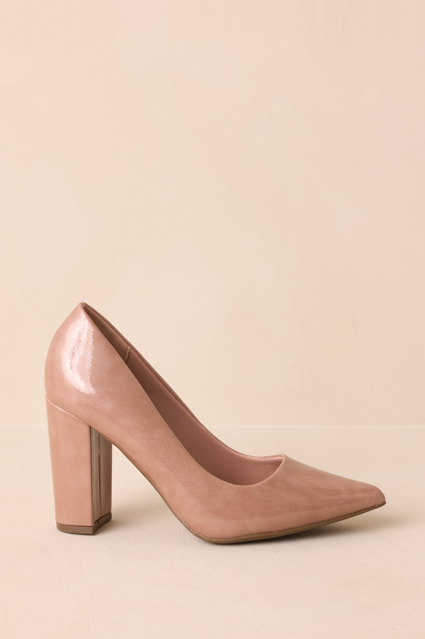 Side view of light mocha pump highlighting pointed toe and block heel.