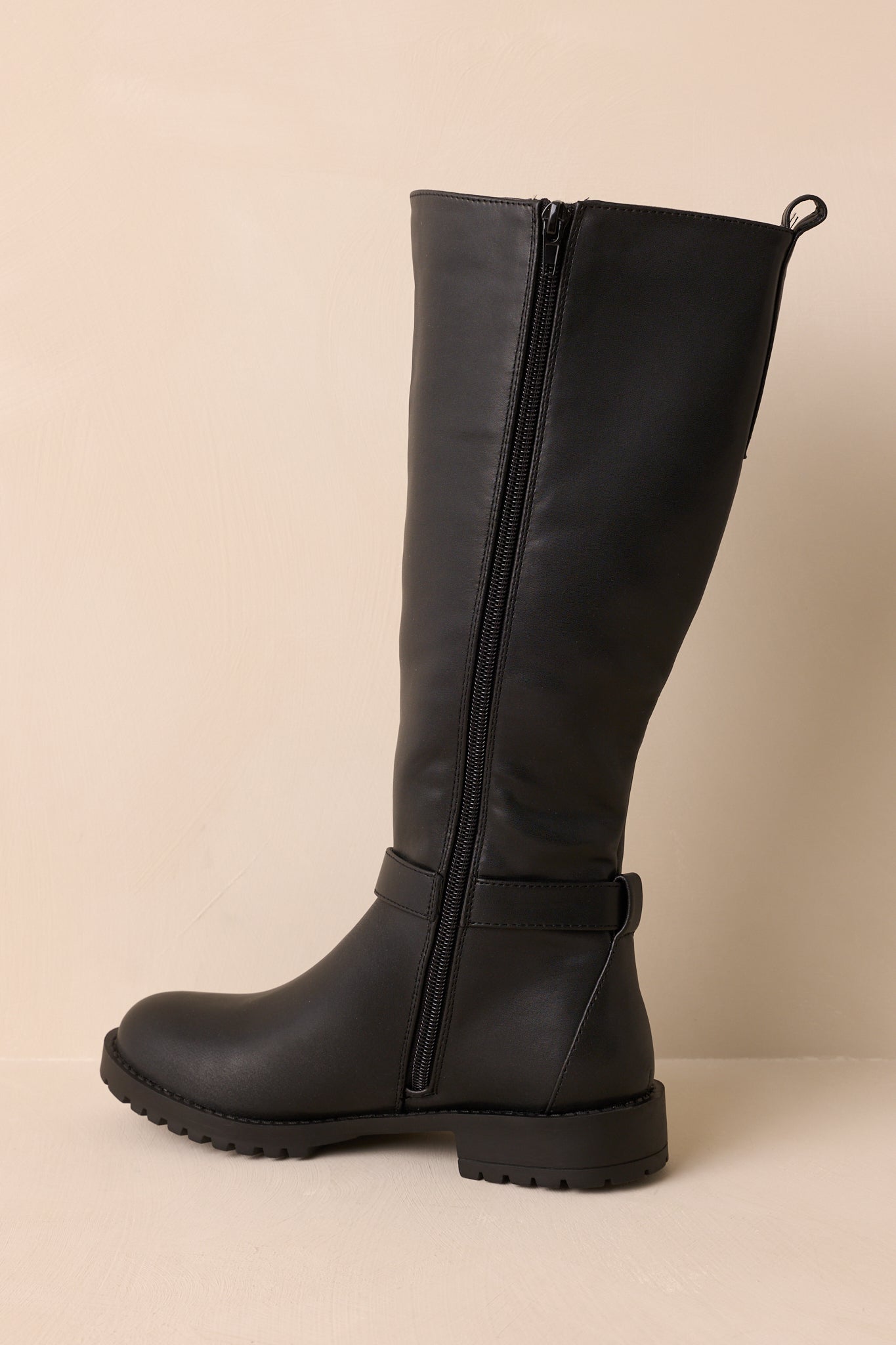 Side view showing decorative ankle strap, elastic panel, and sleek silhouette.