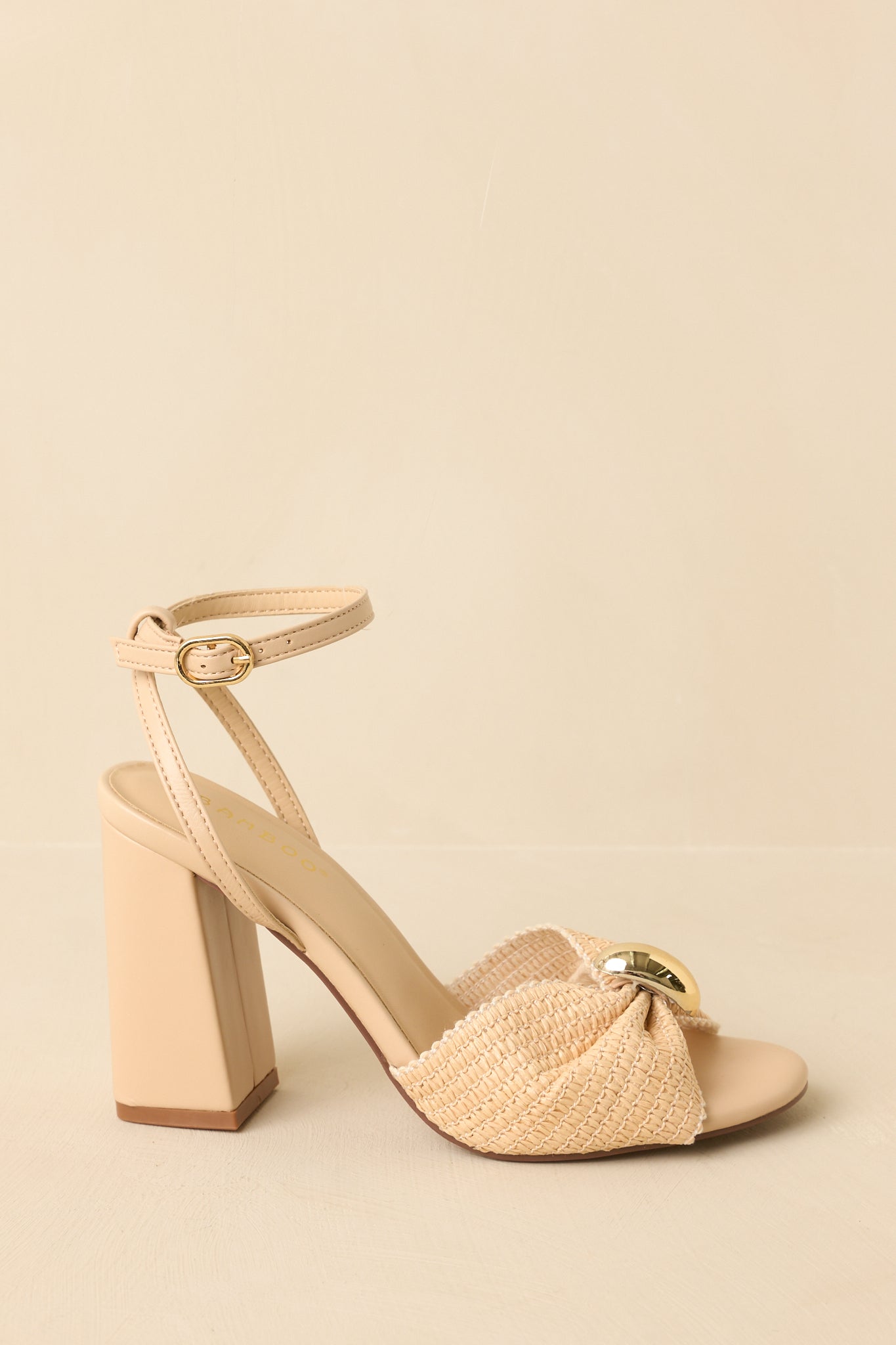 Side view highlighting the adjustable ankle strap, gold-tone accent, and supportive block heel.