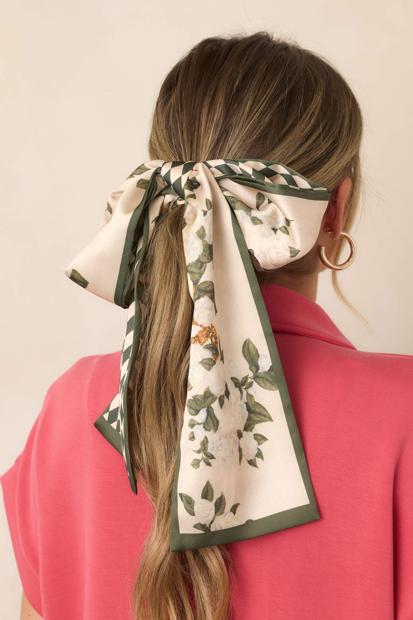 Silky twilly hair scarf featuring rich green tones and a classic forest green diamond pattern with an elongated, narrow silhouette.