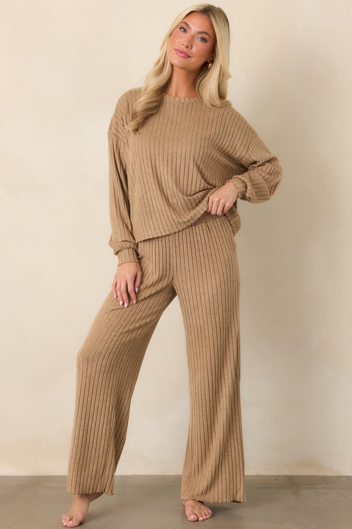 Silky light beige rib pants featuring a comfortable smocked waistband and flowing wide legs for an easy silhouette.