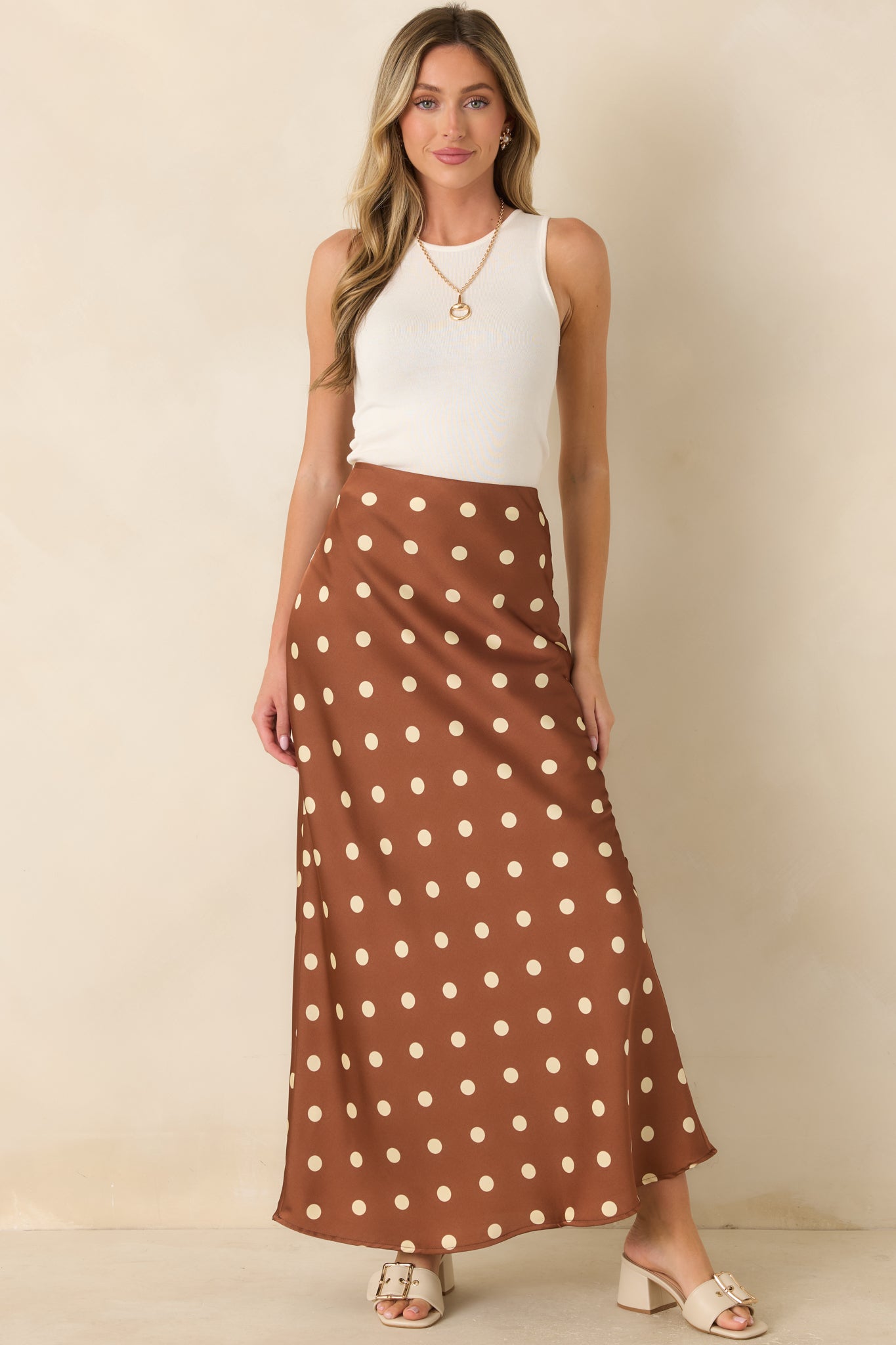 Silky satin maxi skirt designed with a smooth waistband, pull-on styling, and graceful vintage-inspired print.