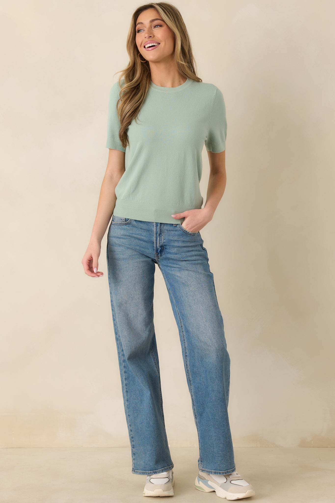 Simple knit top with short sleeves and polished, minimal design.