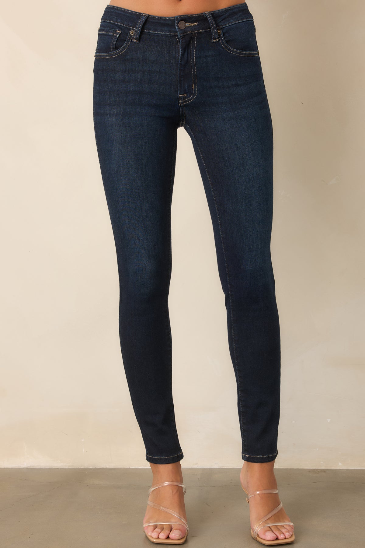 Skinny dark wash jeans featuring clean lines and flexible stretch construction.