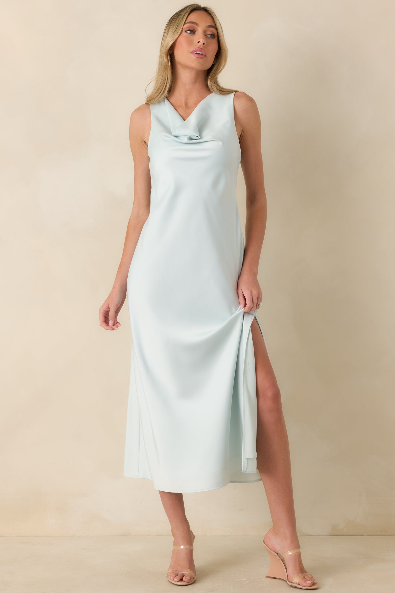 Sky blue satin midi dress with fluid drape, soft cowl neckline, and a clean, streamlined silhouette.