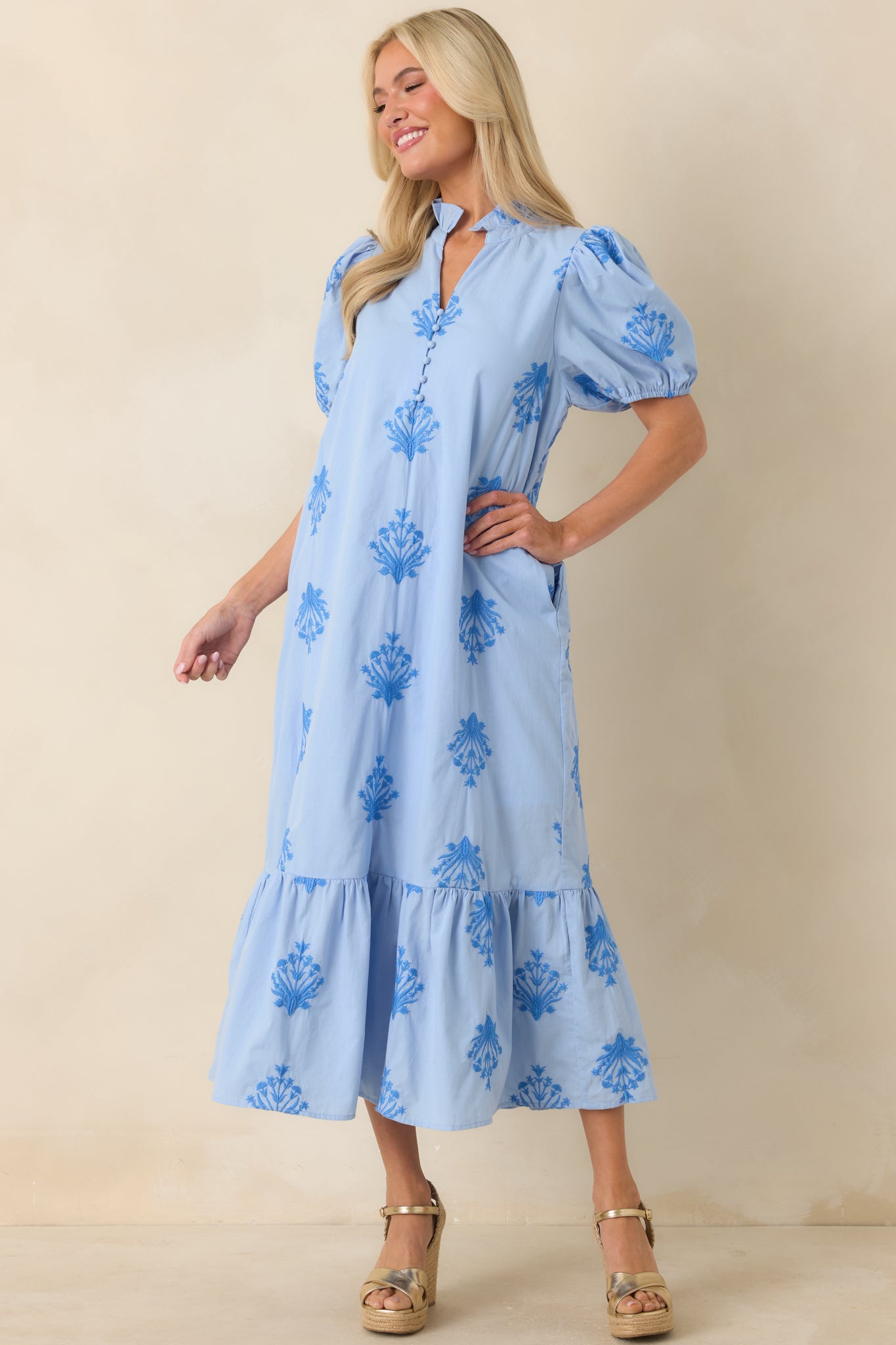 Sky blue cotton dress highlighting tonal embroidery, a relaxed fit, ruffled neckline, and a softly tiered appearance with a feminine finish.