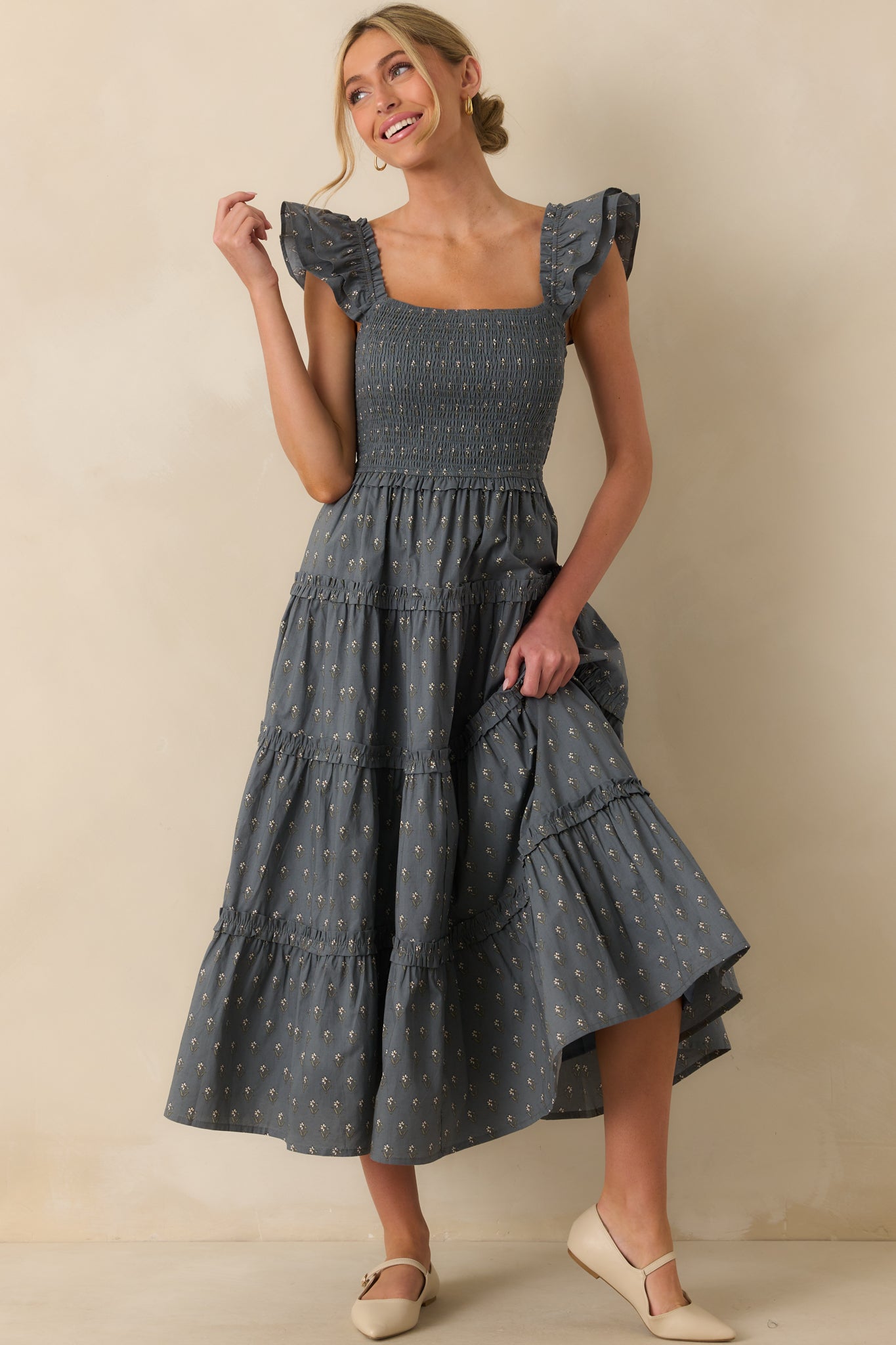 Slate blue midi dress with ivory floral print, featuring a square neckline and ruffle flutter sleeves.