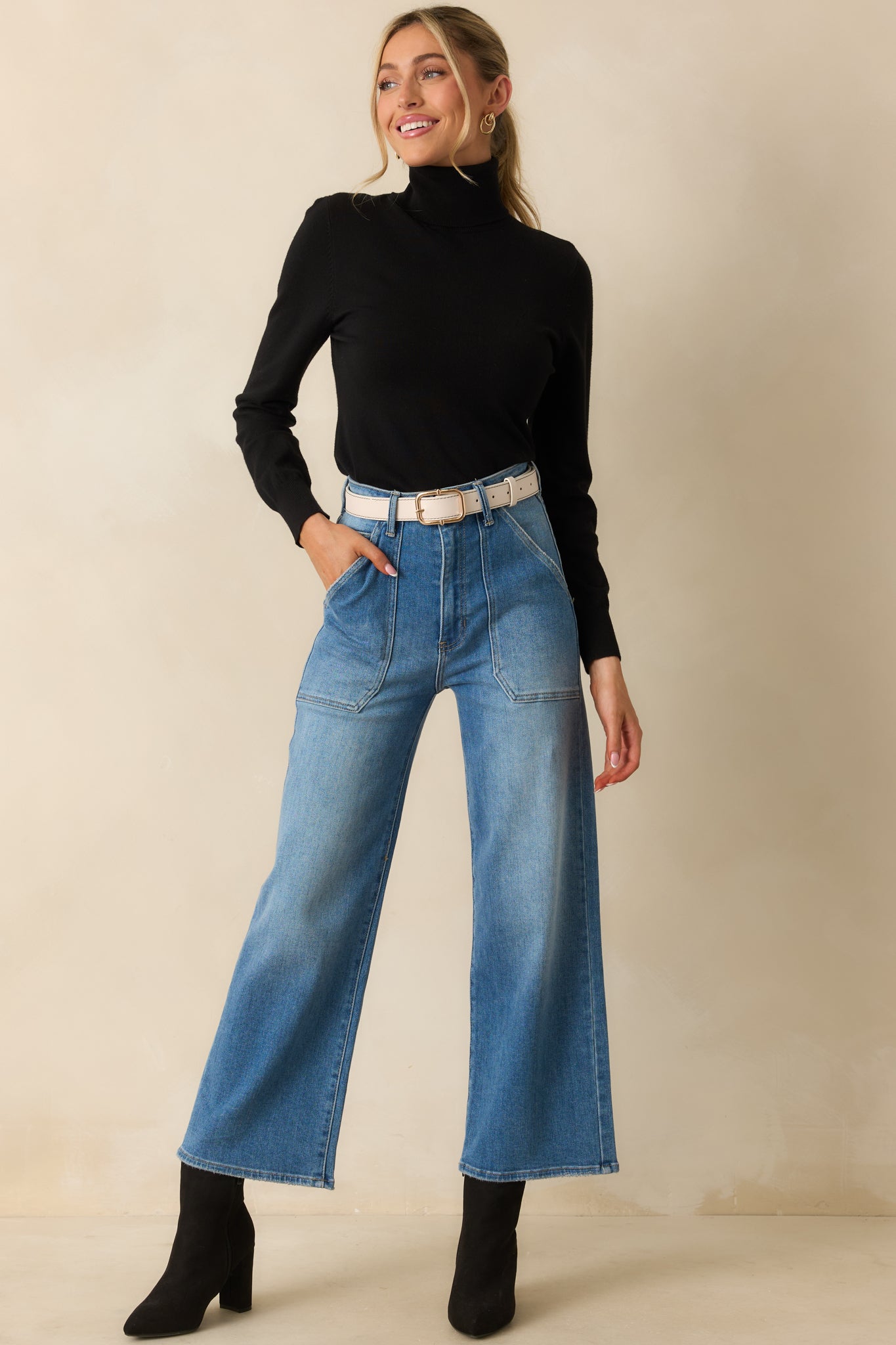 Sleek black sweater with a high neckline and ribbed accents for an effortlessly refined feel.