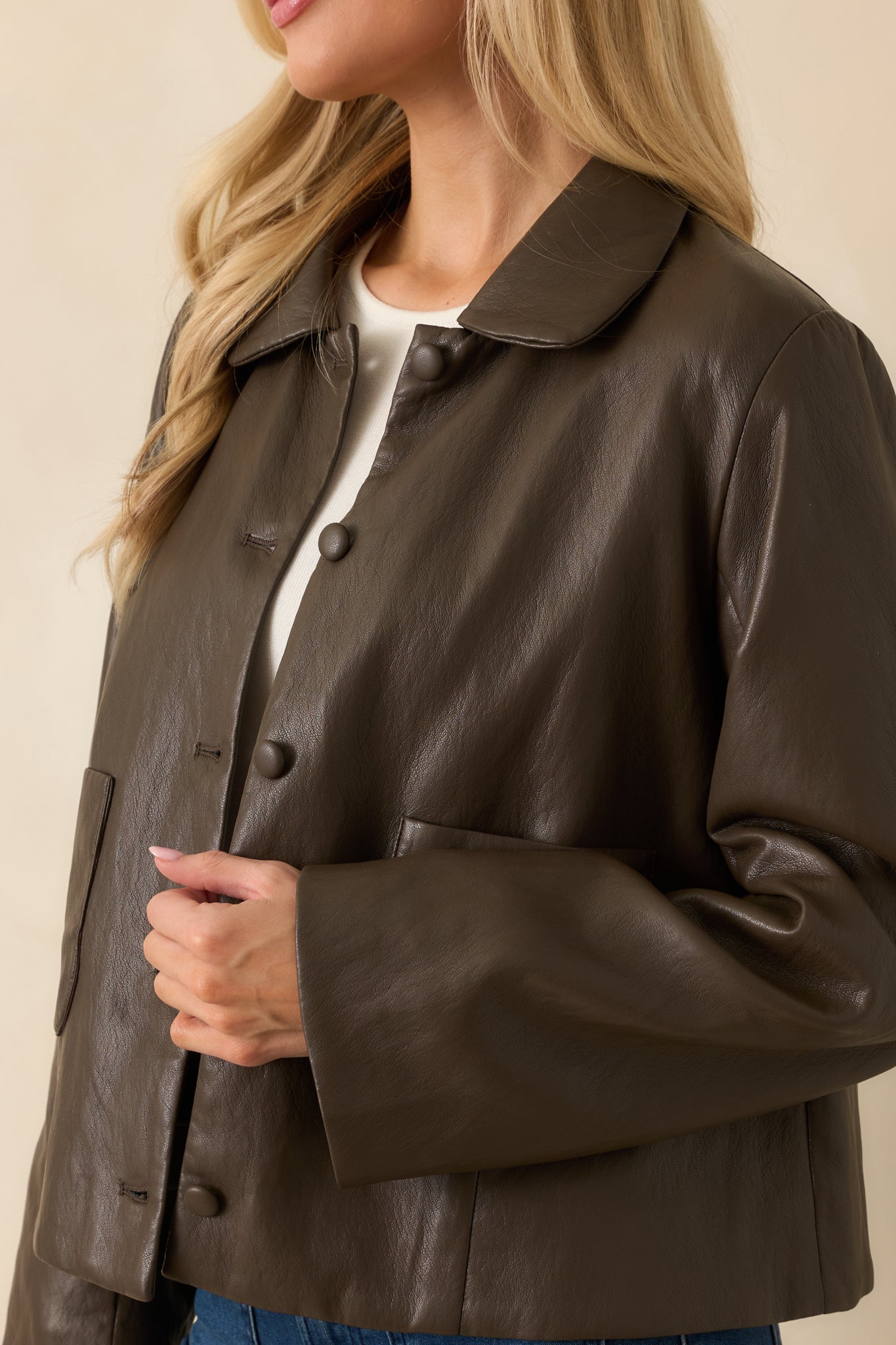 Cropped sleeve detail showing long sleeve length, soft leather finish, and relaxed fit.