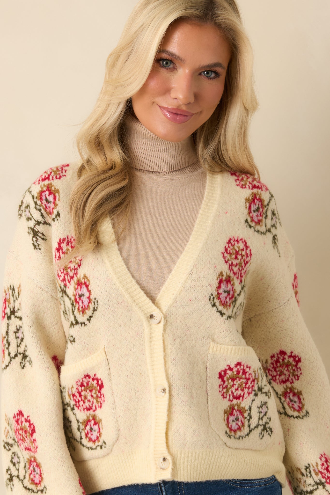 Sleeve and hem ribbing displayed with the cardigan’s vintage floral patterning nearby.