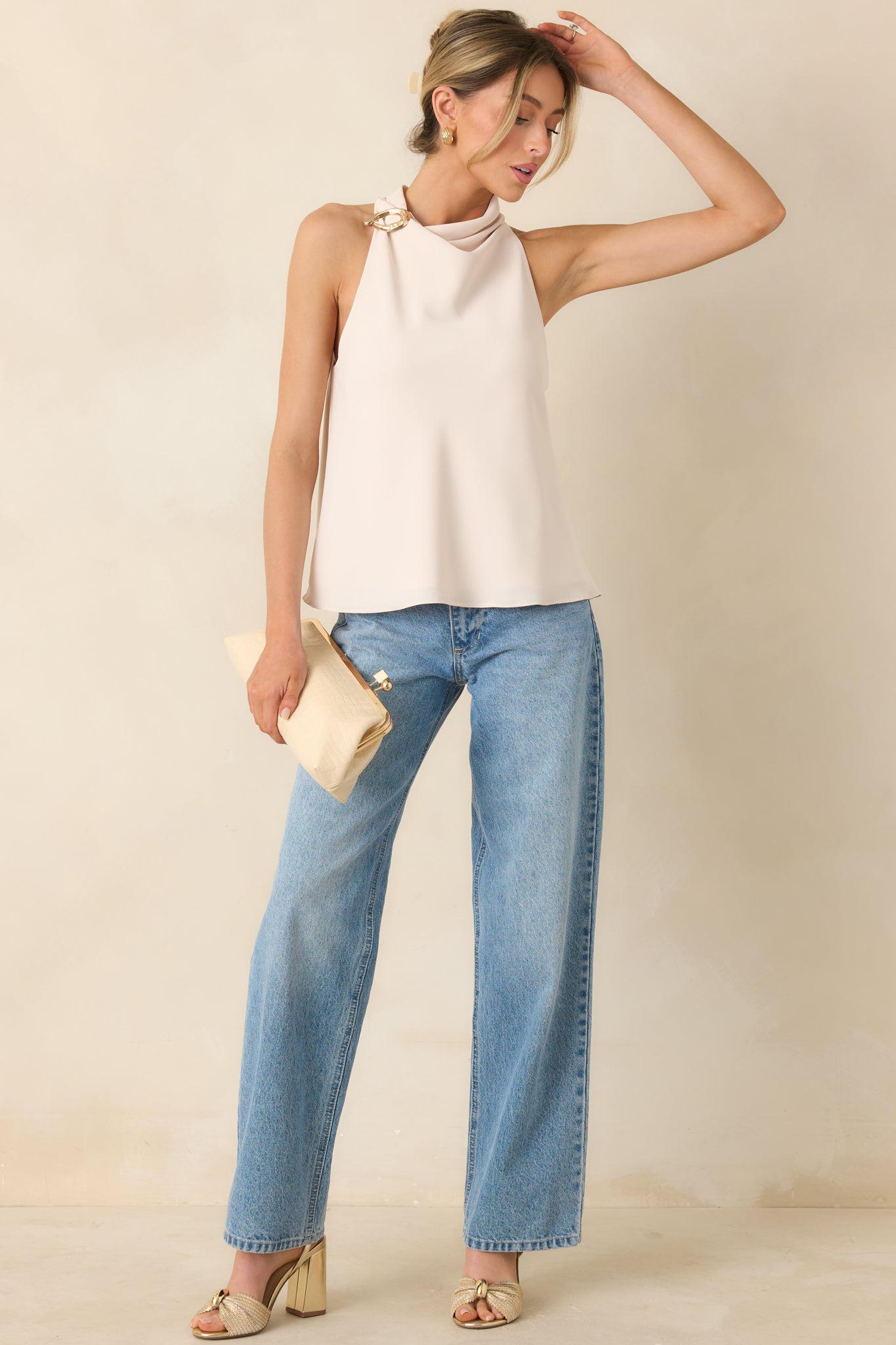 Sleeveless beige top featuring fluid drape and subtle metallic detail.