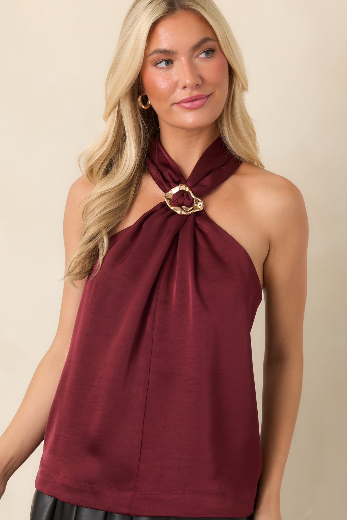 Sleeveless blouse displaying the halter neckline and softly gathered front construction.