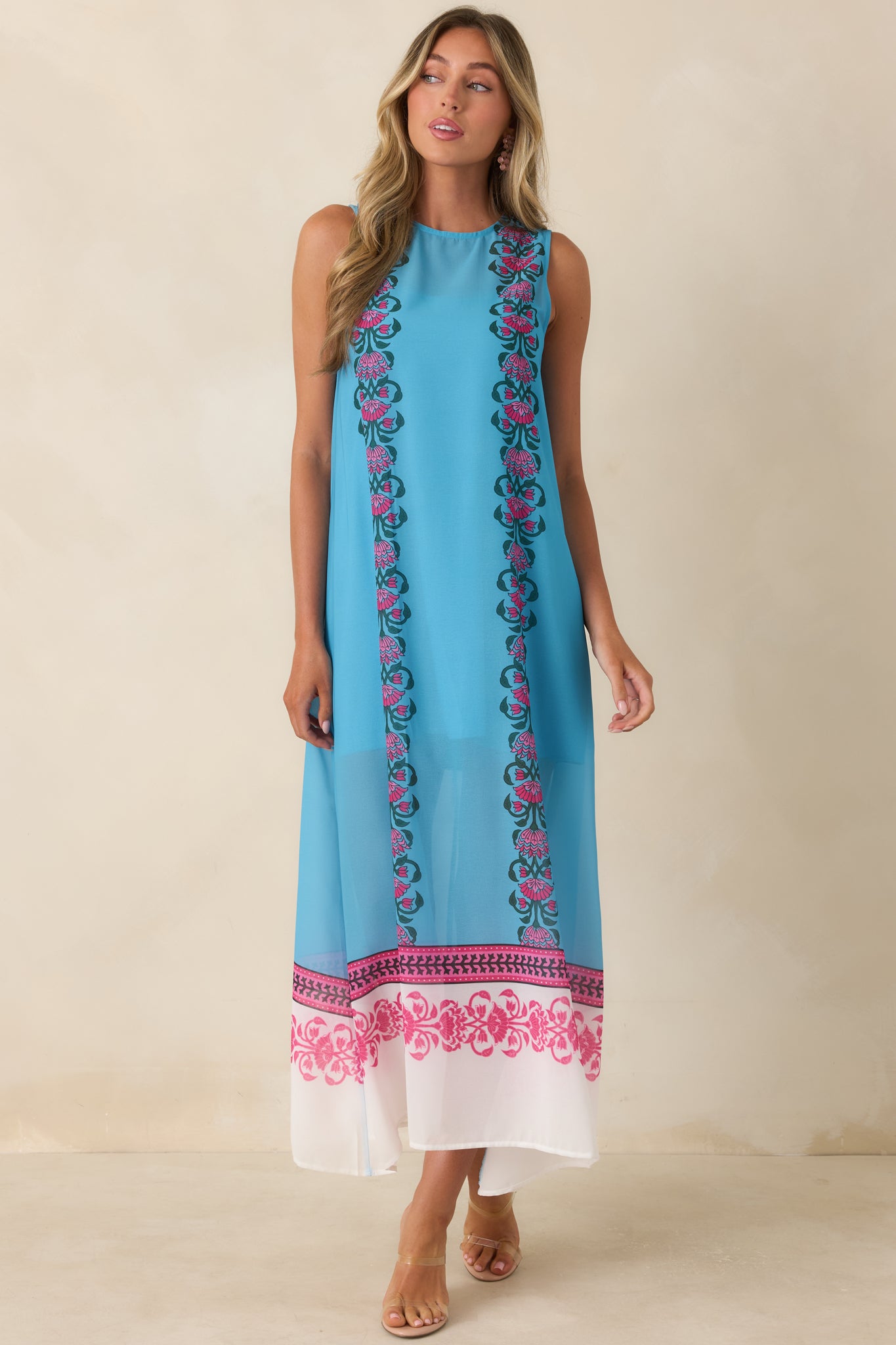 Sleeveless blue maxi dress with a classic round neckline and contrasting floral panels that add dimension and visual interest from top to bottom.