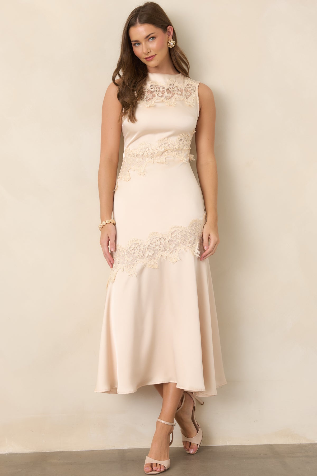 Sleeveless champagne midi dress with intricate lace accents framing the bodice and lower skirt.