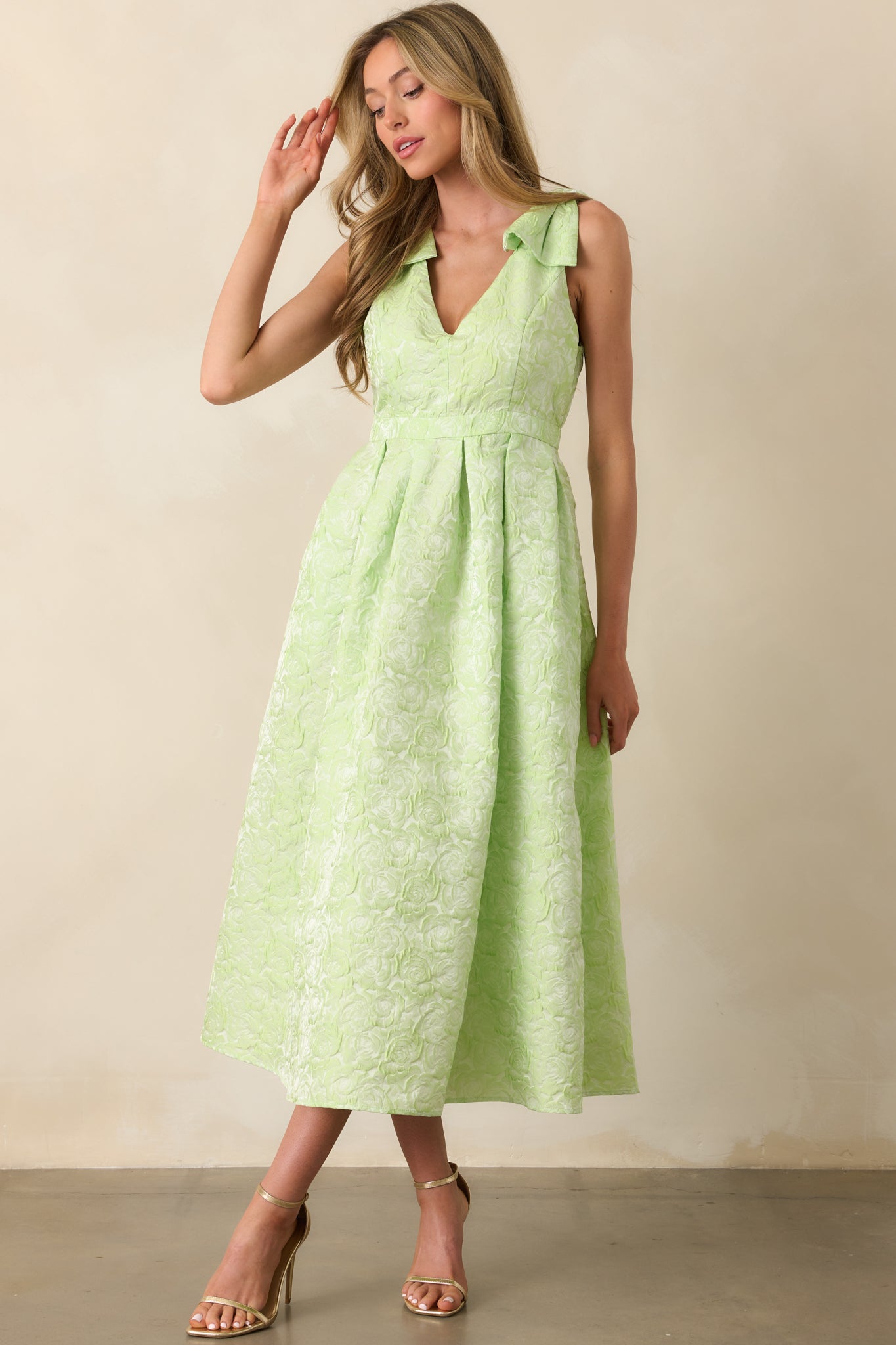 Sleeveless chartreuse dress with self-tie bow straps, v-neckline, and two side pockets for added functionality.