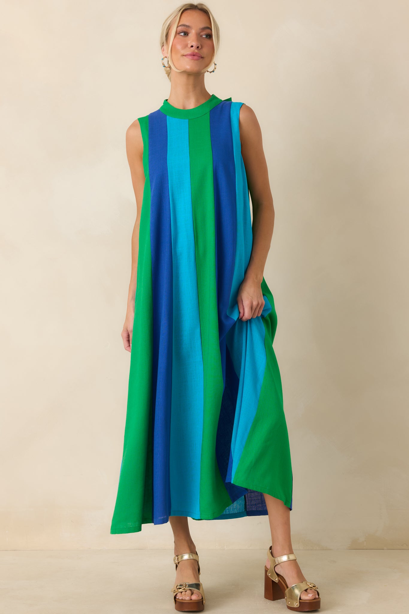 Sleeveless dress designed with striking green and blue colorblock sections that create a lengthening effect.
