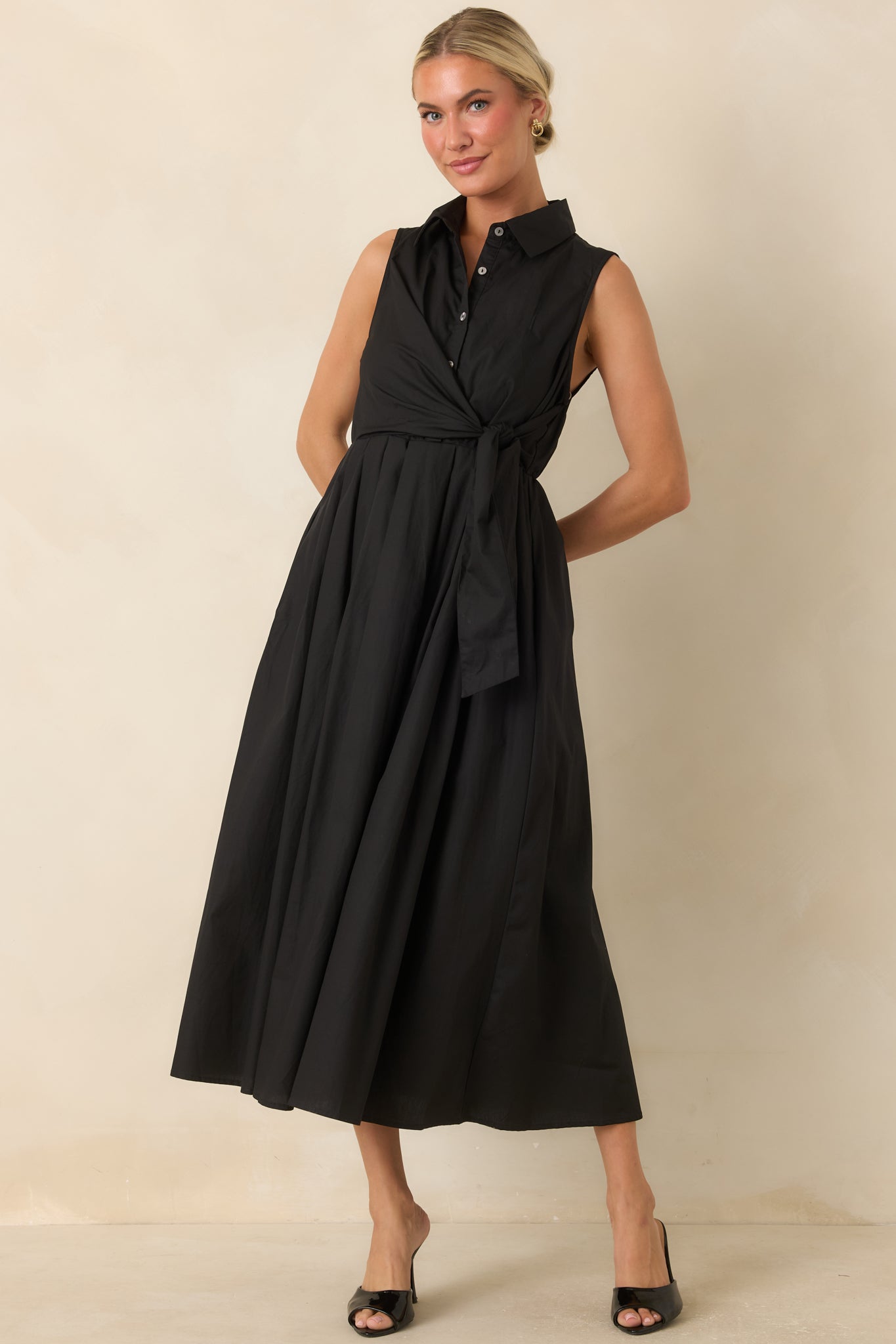 Sleeveless cotton midi dress featuring a faux wrap front, soft lining, and relaxed flowing silhouette.