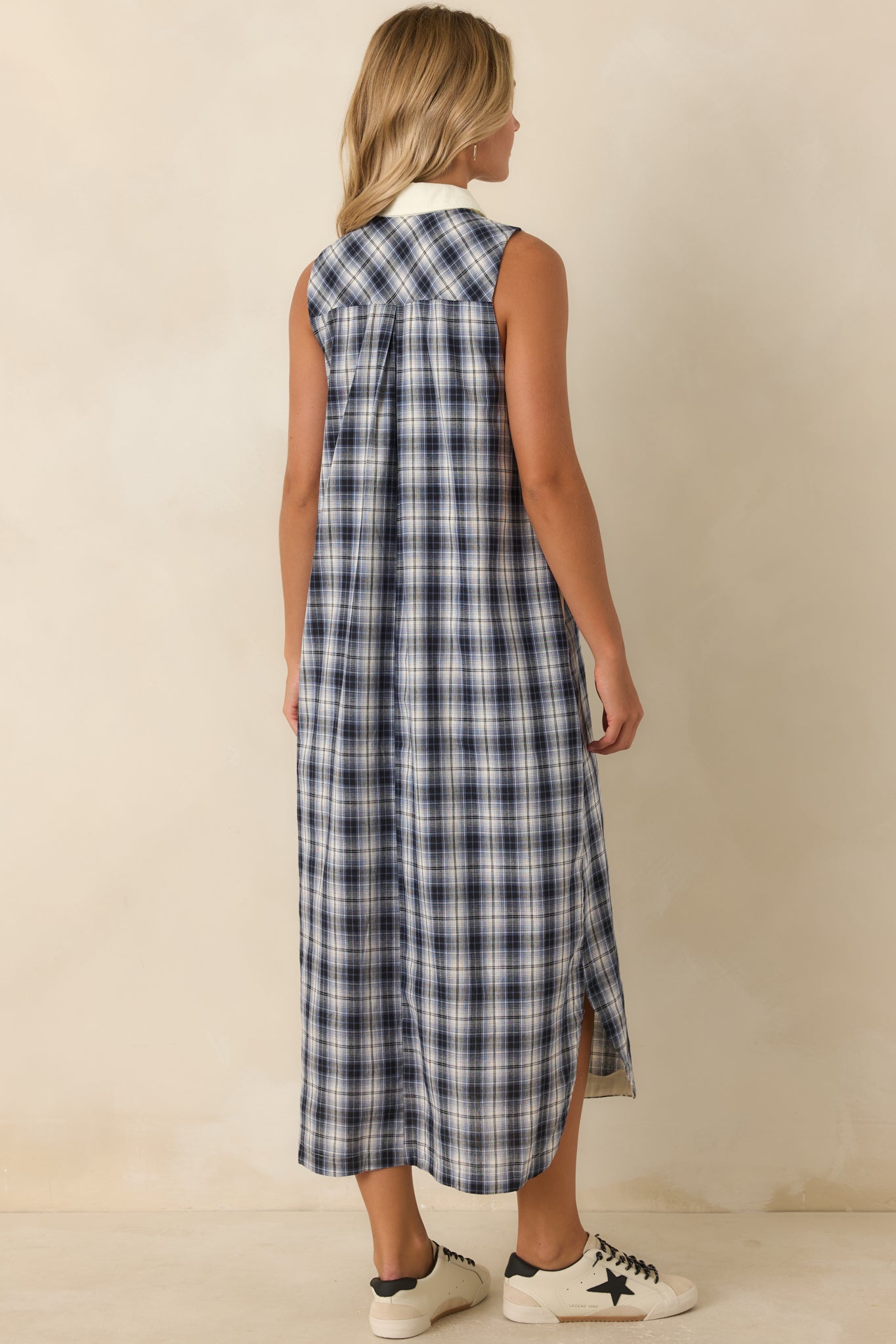 Rear view of the sleeveless cotton dress featuring a relaxed drape and clean minimalist silhouette.