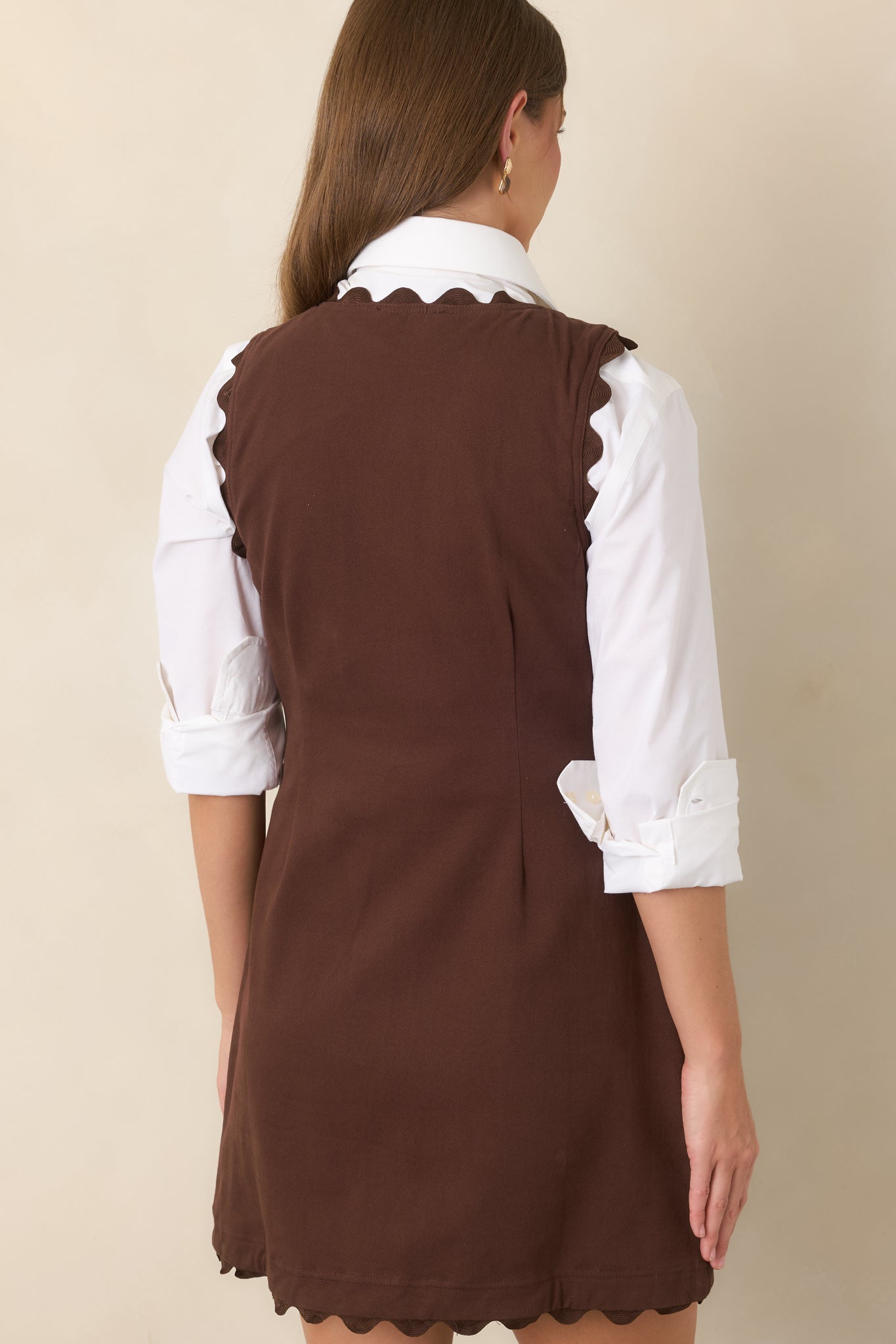 Rear view of the sleeveless cotton-rich mini dress showcasing its clean fitted silhouette and waist-defining shaping seams.