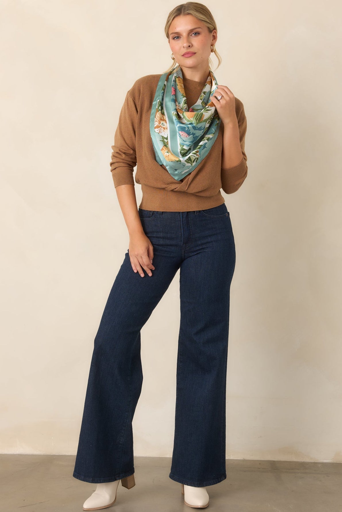 Sleeveless crewneck sweater top featuring a coordinating long-sleeve overlay and wide ribbed hem.