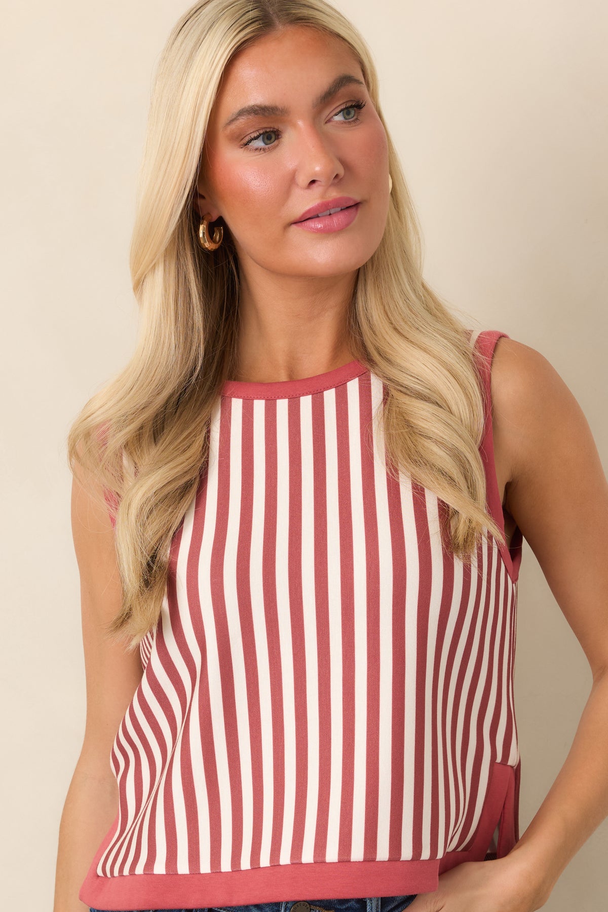 Sleeveless cropped silhouette defined by slender terracotta and ivory stripes, a neat rounded collar, and coordinating terracotta trim.