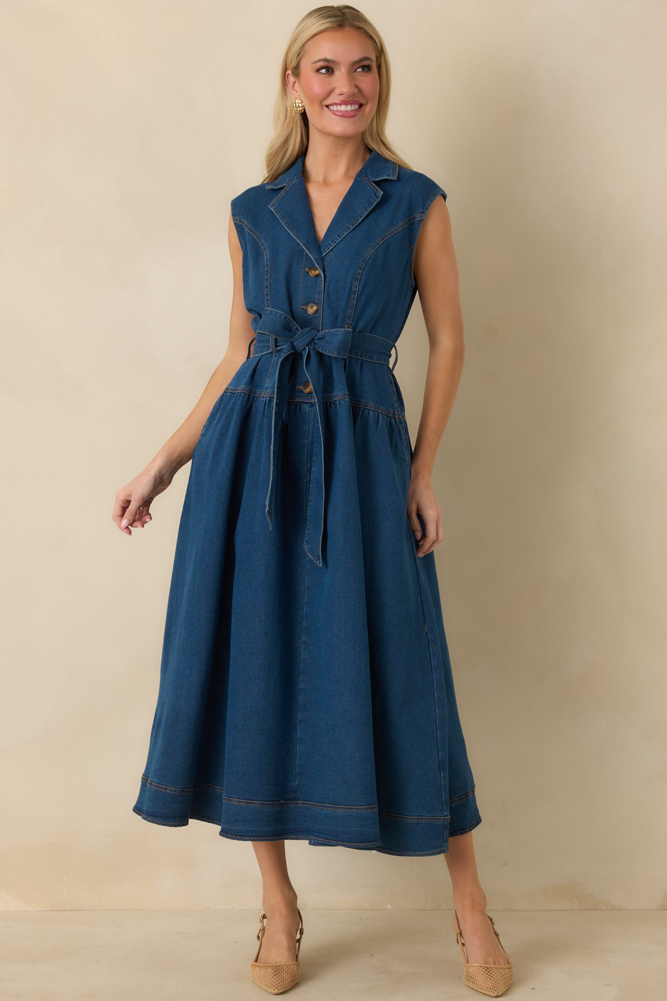 Sleeveless dark wash midi dress with A-line gathered skirt and gold-tone hardware on front buttons.