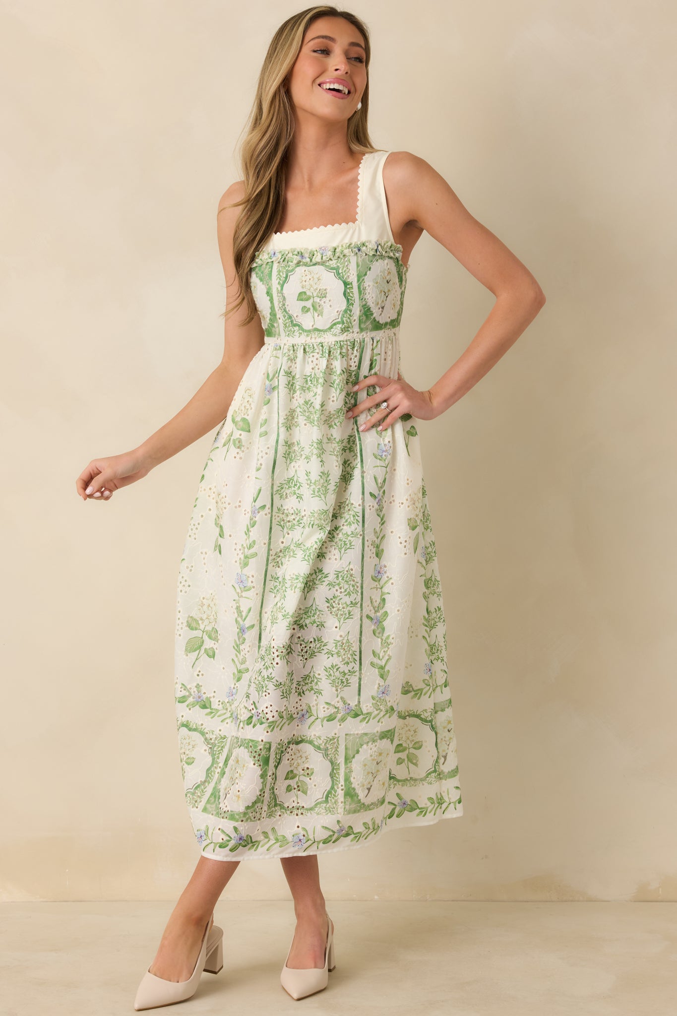 Sleeveless floral maxi dress showcasing the structured bodice, delicate eyelet accents, and softly flowing skirt with panel-inspired floral patterns.