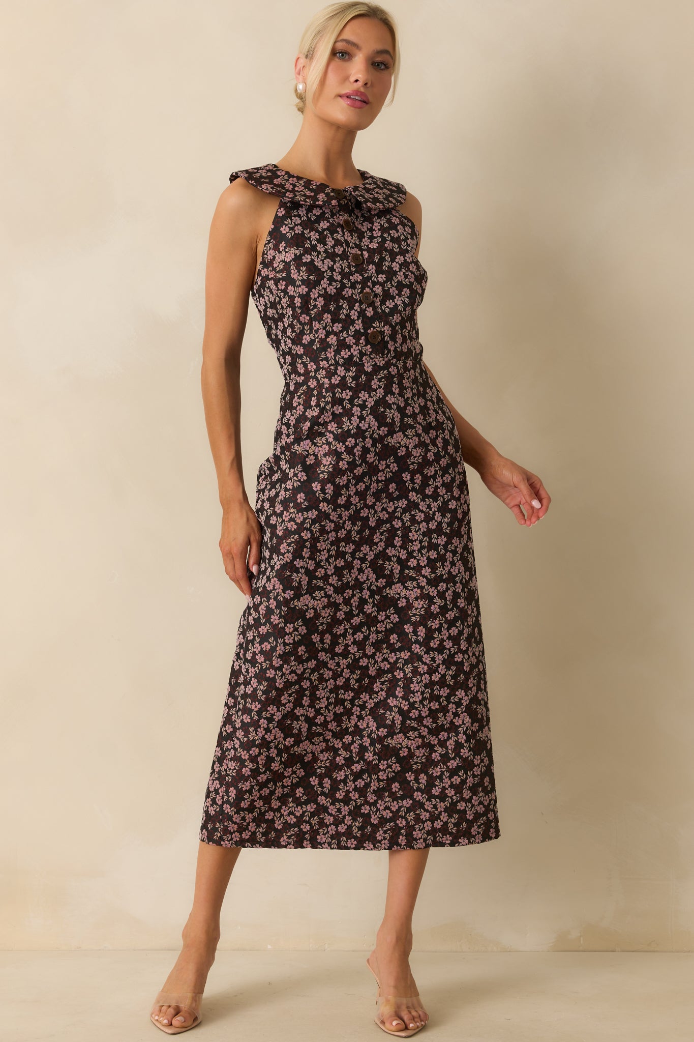 Sleeveless floral midi dress with a faux button front bodice and structured silhouette.
