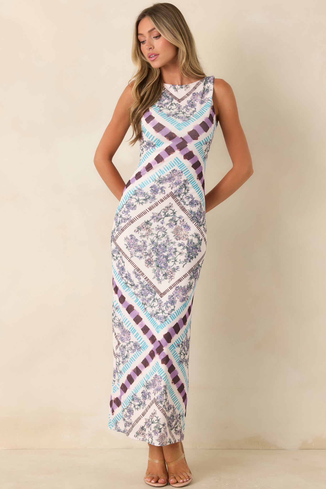 Sleeveless floral midi dress featuring a sleek silhouette, polished neckline, and timeless romantic style.