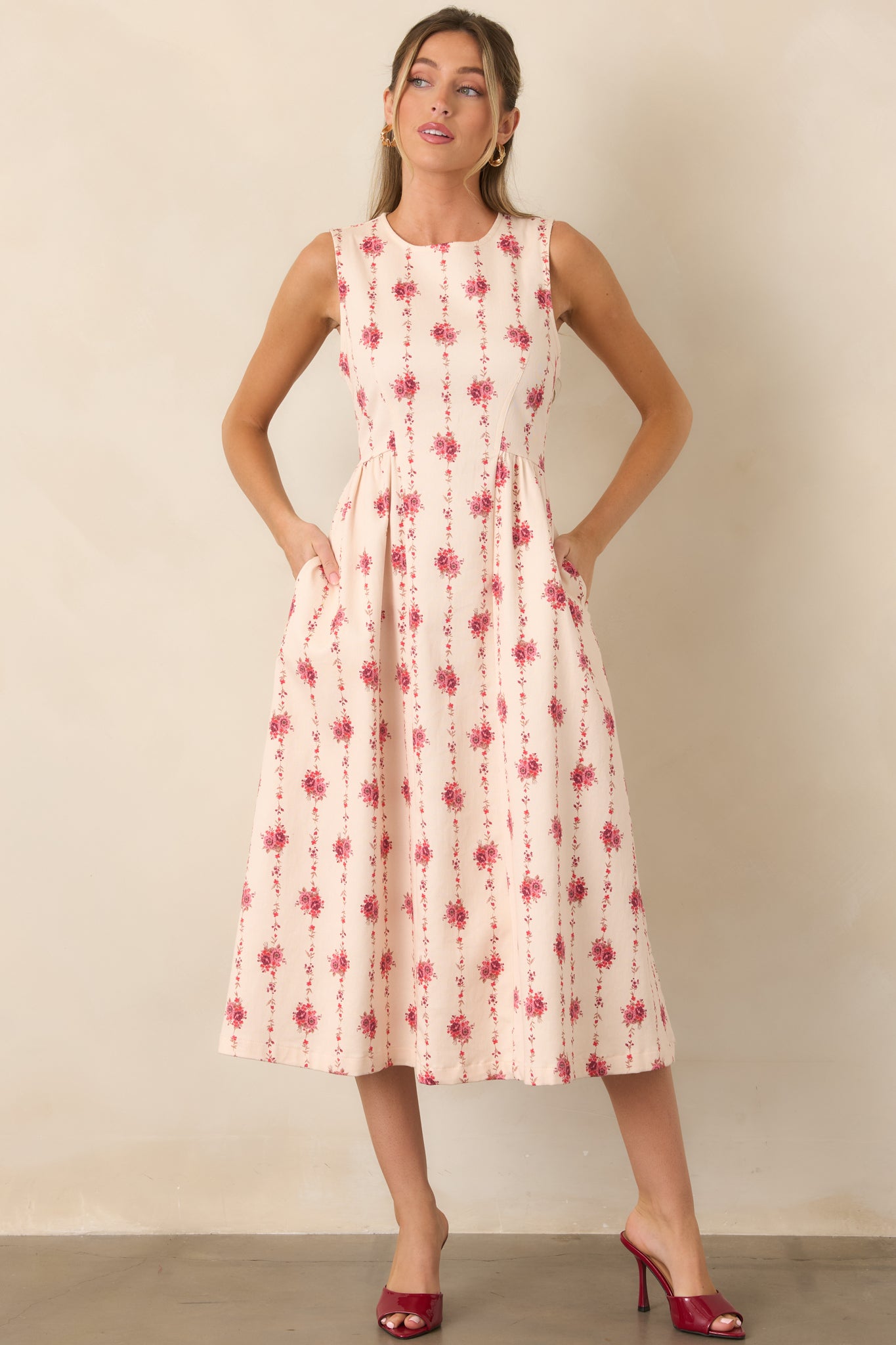 Sleeveless fit-and-flare midi dress designed with princess-seam shaping and an elongated floral stripe pattern.