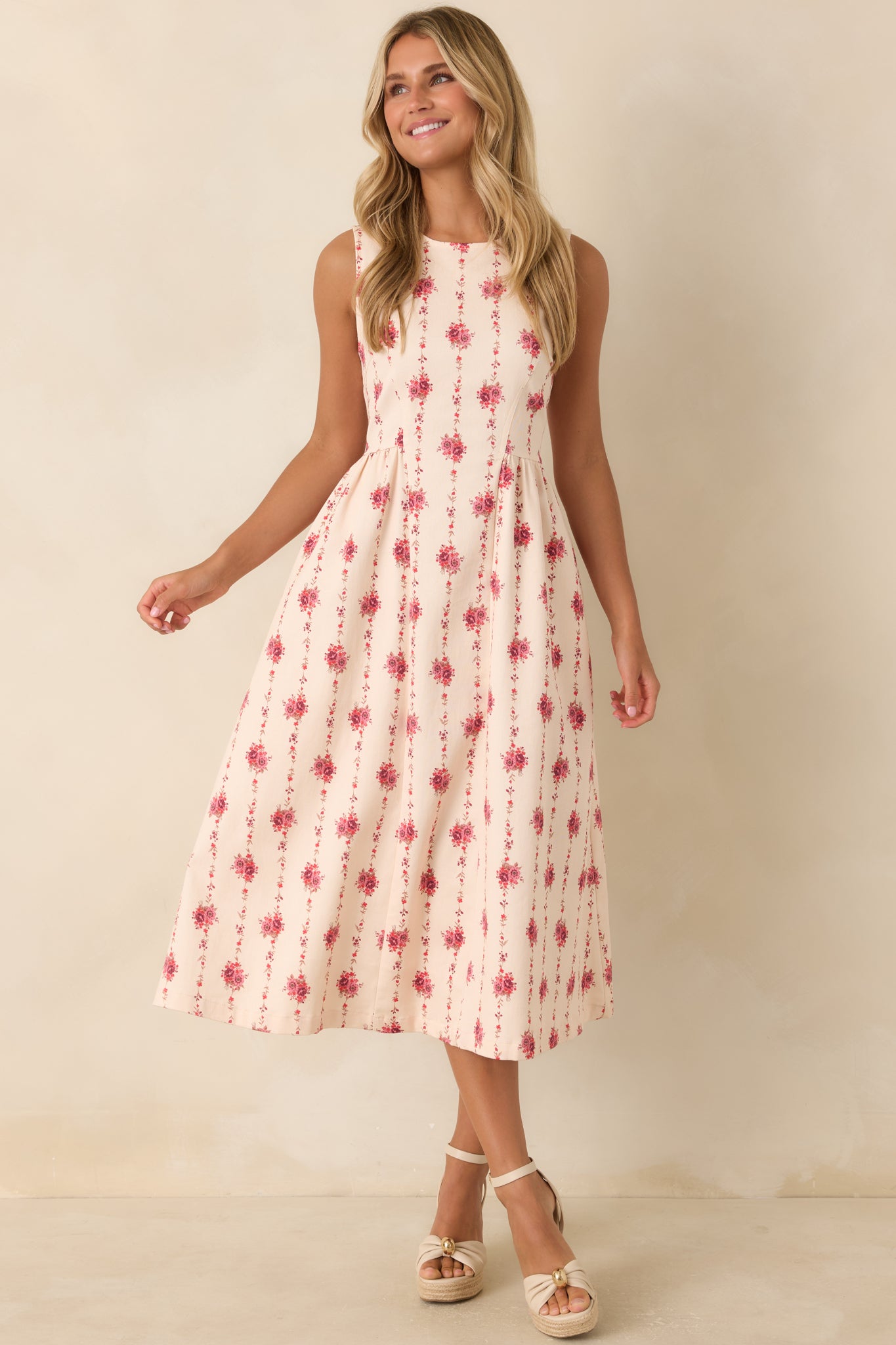 Sleeveless floral stripe midi dress featuring a tailored princess-seam bodice, fit-and-flare silhouette, and hidden side pockets.