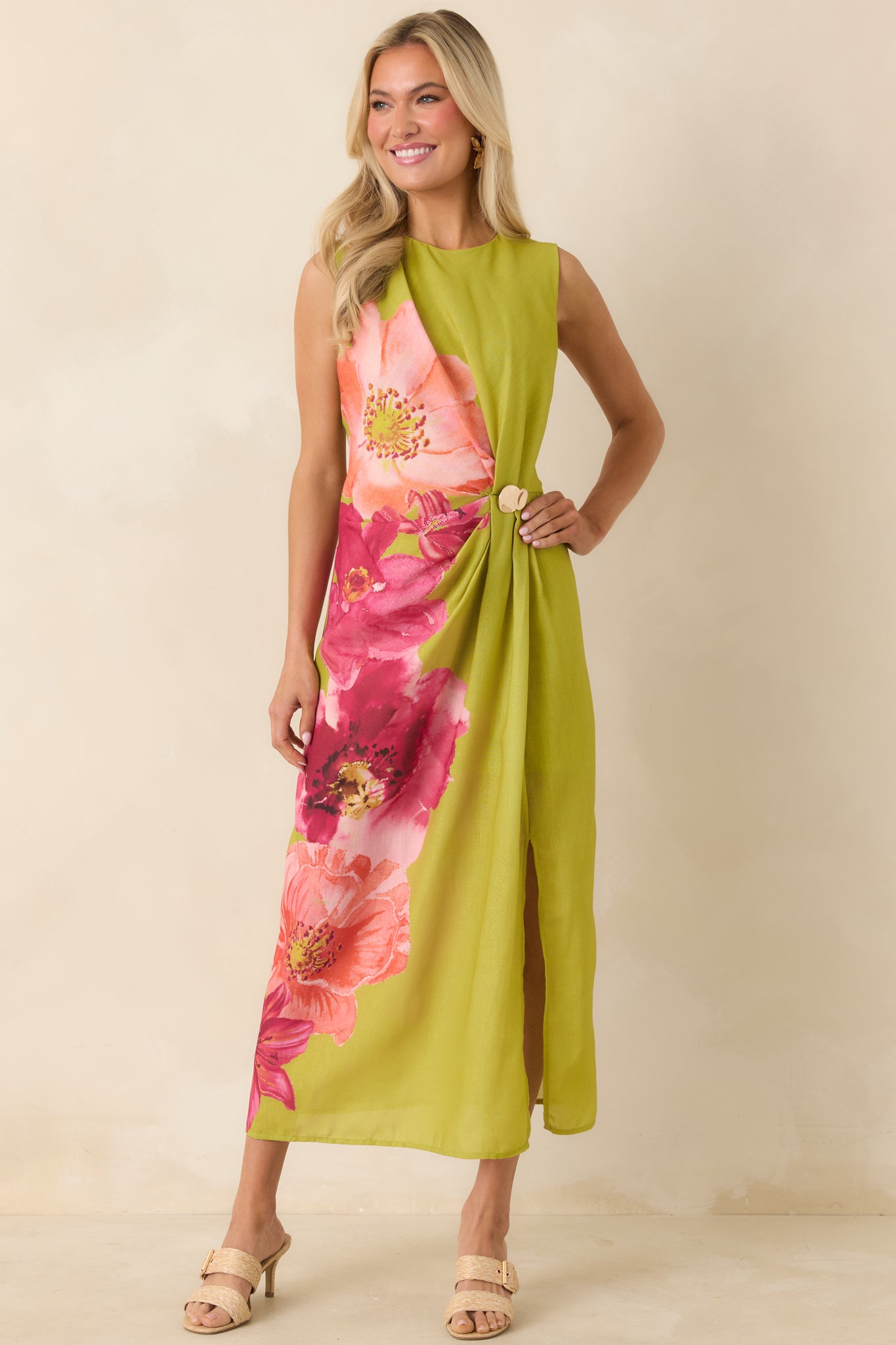 Sleeveless green floral dress with smooth lining, side pleating, and versatile midi length.