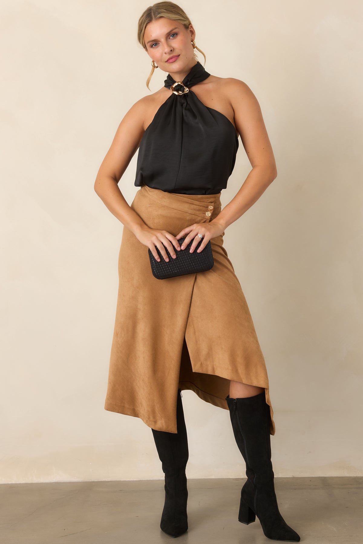 Sleeveless halter top with a softly draped silhouette and statement neckline accent.